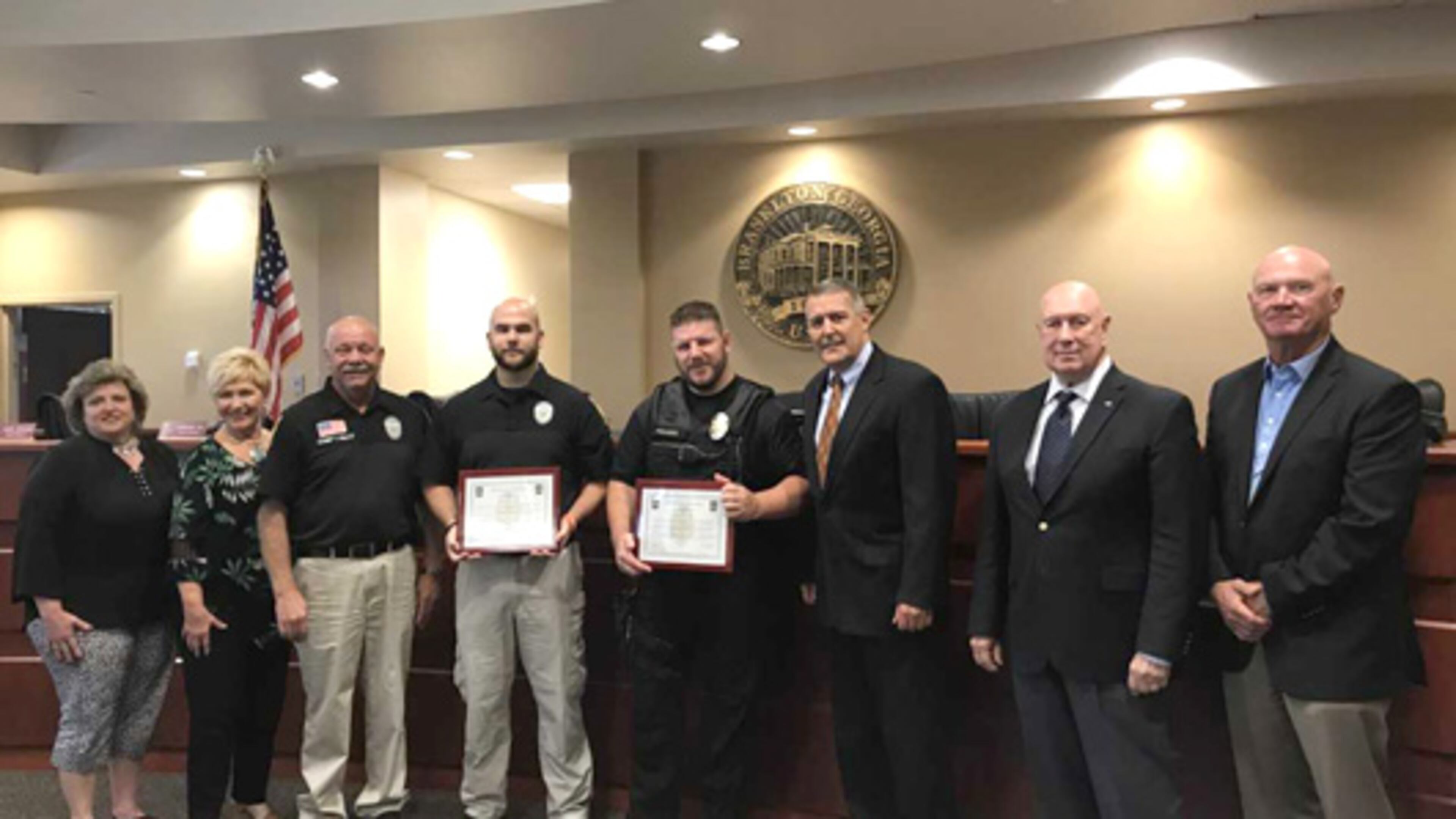 Left to right: Councilwomen Becky Richardson and Peggy Slappey, Police Chief Terry Esco, Officer Josh Lindsay, Sgt. Steven Folkers, Mayor Bill Orr and Councilmen Tony Funari and Hardy Johnson honor police officers for lifesaving actions. Courtesy Town of Braselton
