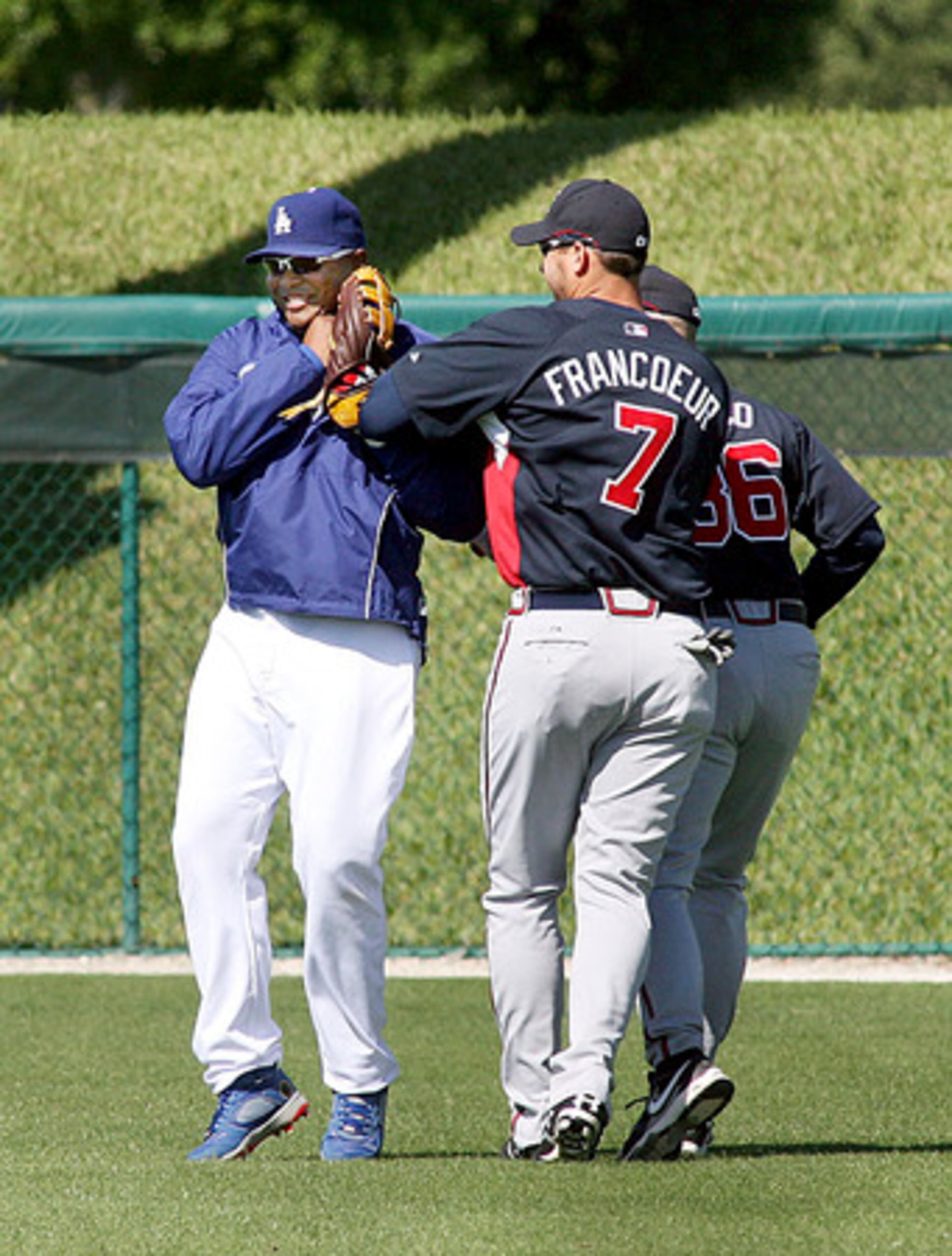 Jones is chastised by former teammates Jeff Francoeur as the Braves take the field for stretching.