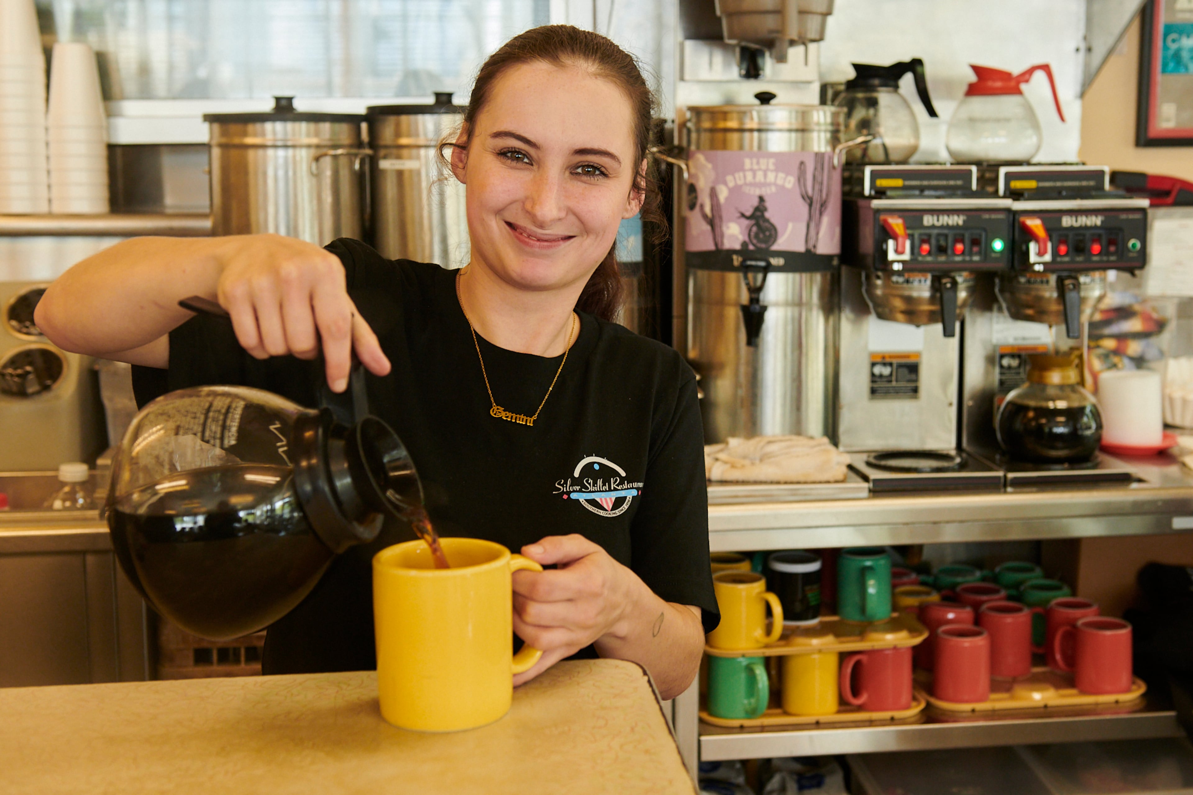 Haylee Elrod fills a customer's coffee cup at the Silver Skillet in Atlanta. (Greg Rannells for The Atlanta Journal-Constitution)