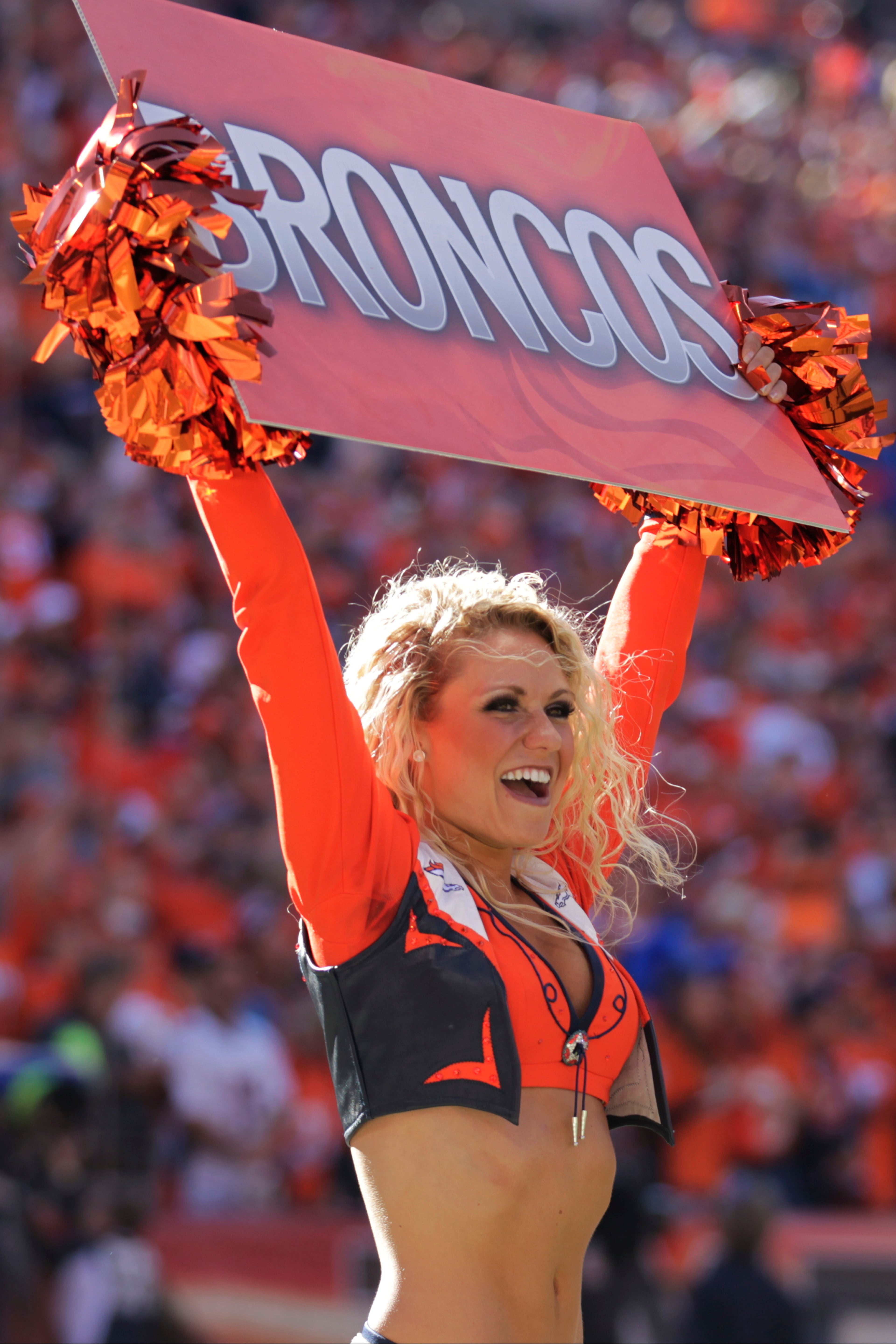 A Denver Broncos cheerleader performs during the first half of the AFC Championship NFL playoff football game against the New England Patriots in Denver on Jan. 19, 2014.