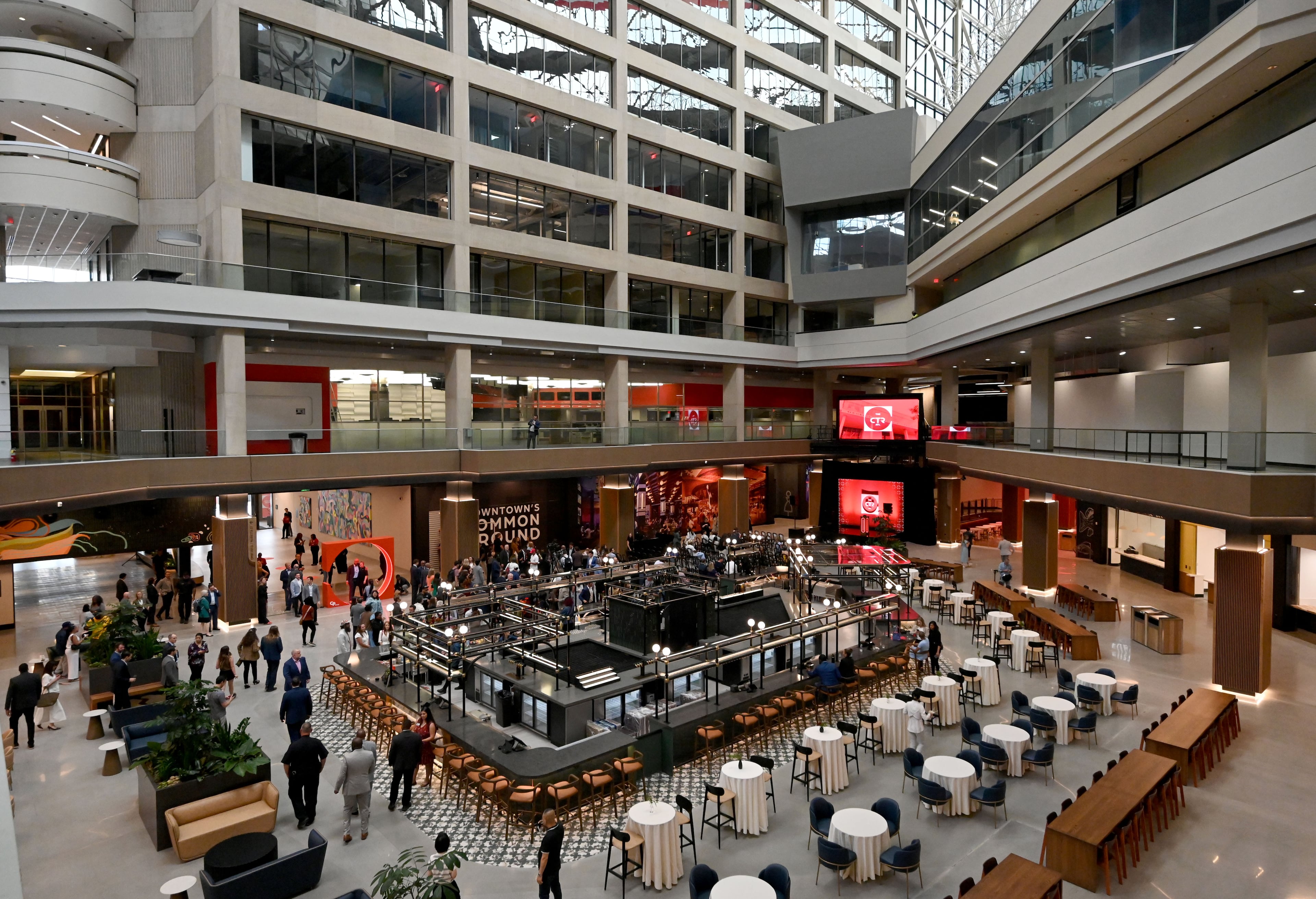 Guests mingle ahead of an unveiling event at The CTR, the former CNN Center, on Wednesday, May 20, 2026, in Atlanta. The former CNN Center in downtown Atlanta has been rebranded and unveiled as The CTR (stylized as "The Center"). CP Group, the property's owners, are transforming the iconic 1.2-million-square-foot complex into a massive mixed-use hub featuring a revamped food hall, experiential entertainment, and public art. (Hyosub Shin/AJC)