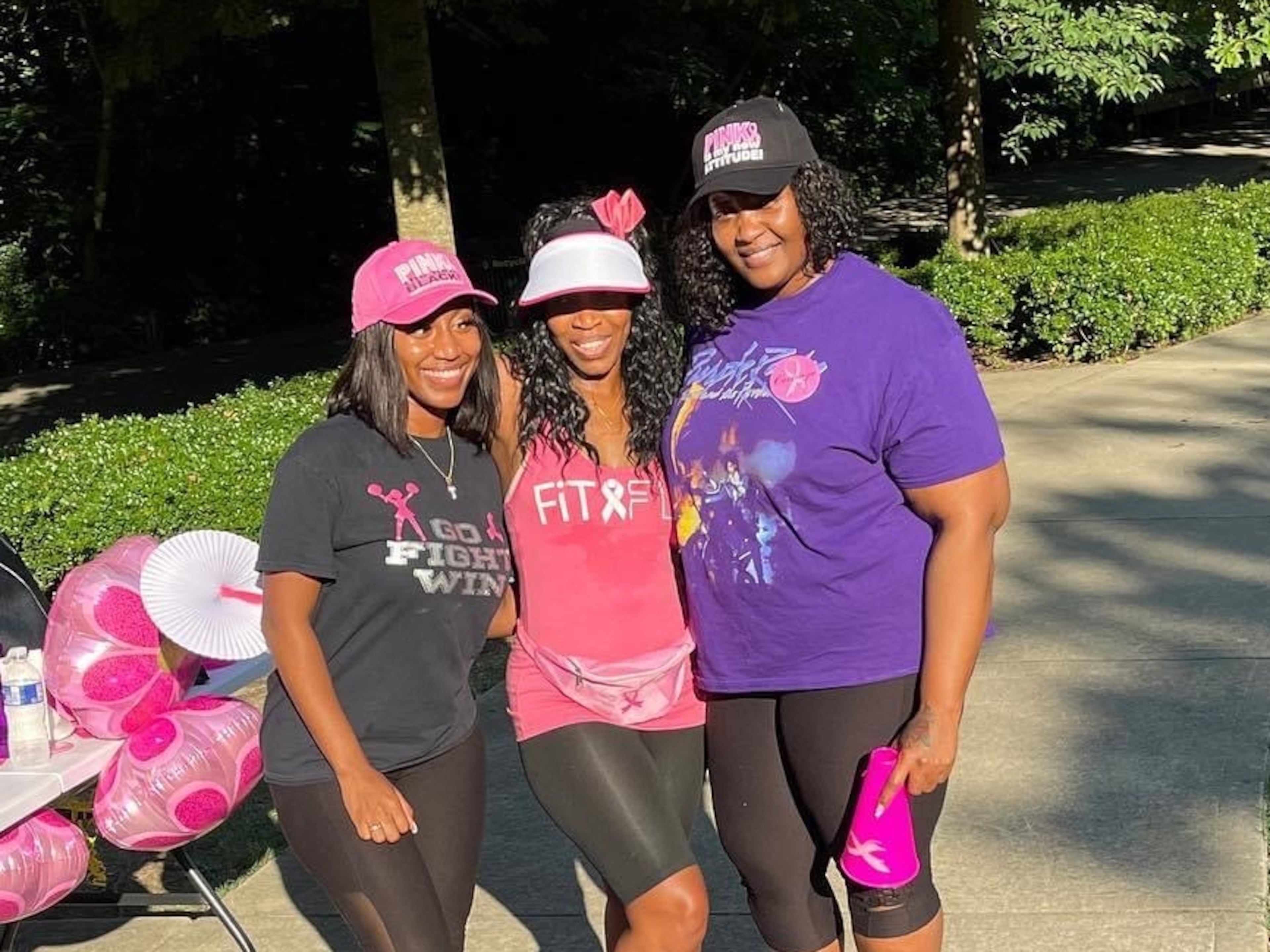 Faridah Thomas, center, with daughter Teriah Blossomgame and family friend Amika Clark at a breast cancer awareness event in Piedmont Park in 2022. (Courtesy of Veronda Calloway)