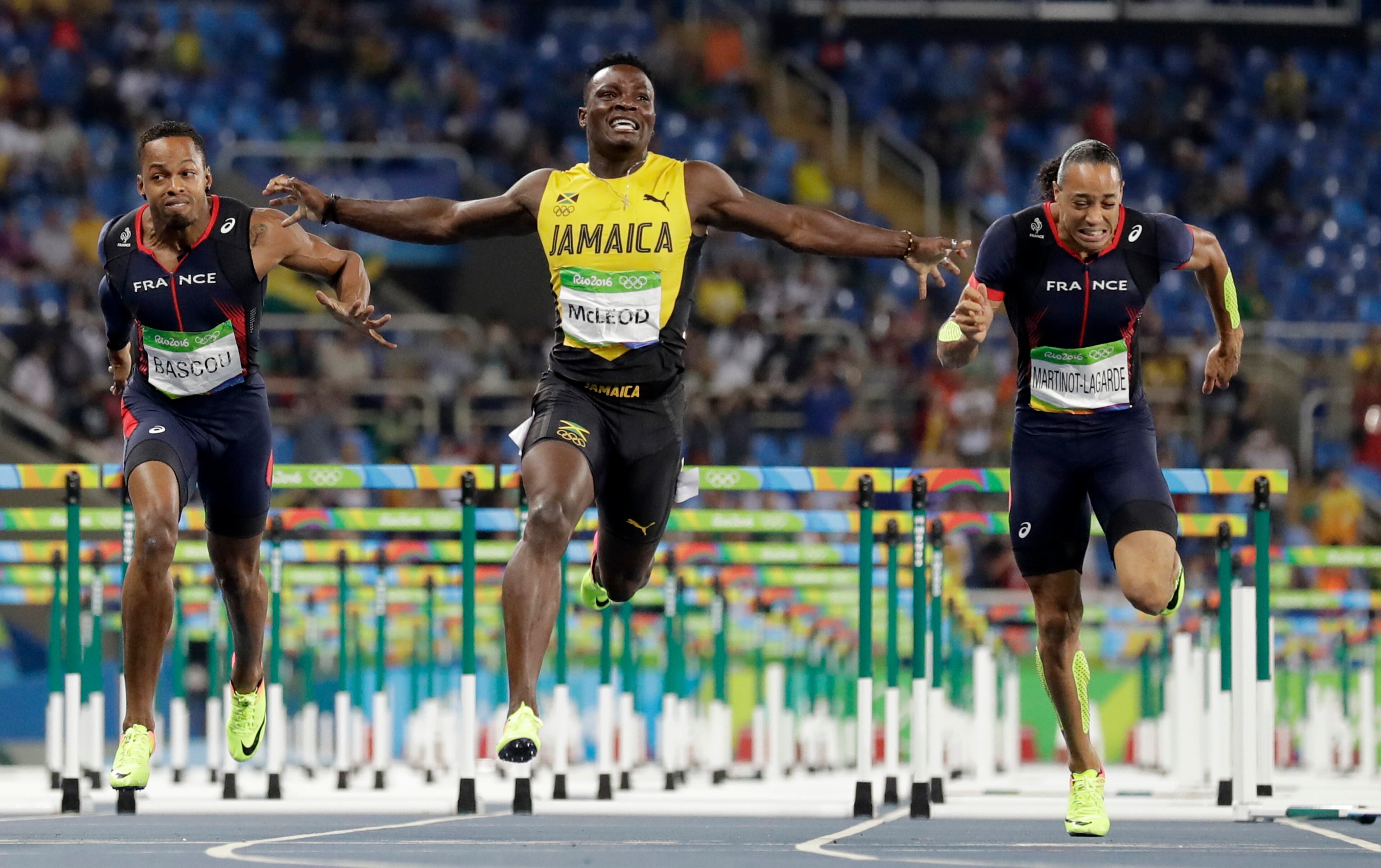 Jamaica's Omar Mcleod, center, wins the men's 110-meter hurdles final ahead of third placed France's Dimitri Bascou, left, and fourth placed France's Pascal Martinot-Lagarde during the athletics competitions of the 2016 Summer Olympics at the Olympic stadium in Rio de Janeiro, Brazil, Tuesday, Aug. 16, 2016. (AP Photo/David J. Phillip)