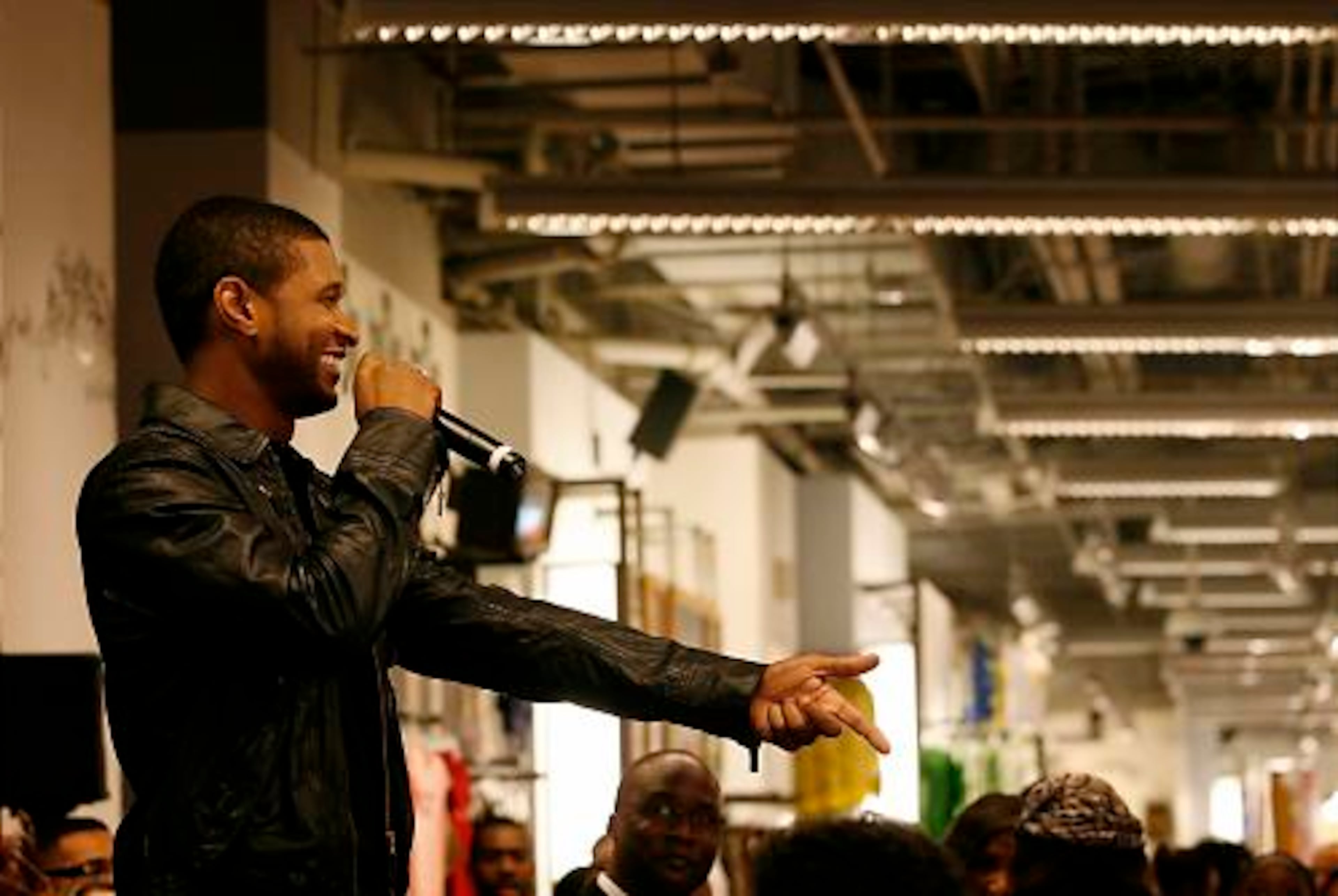 Usher greets fans and media as he debuts his new fragrance at Macy's Lenox Square on Thursday.