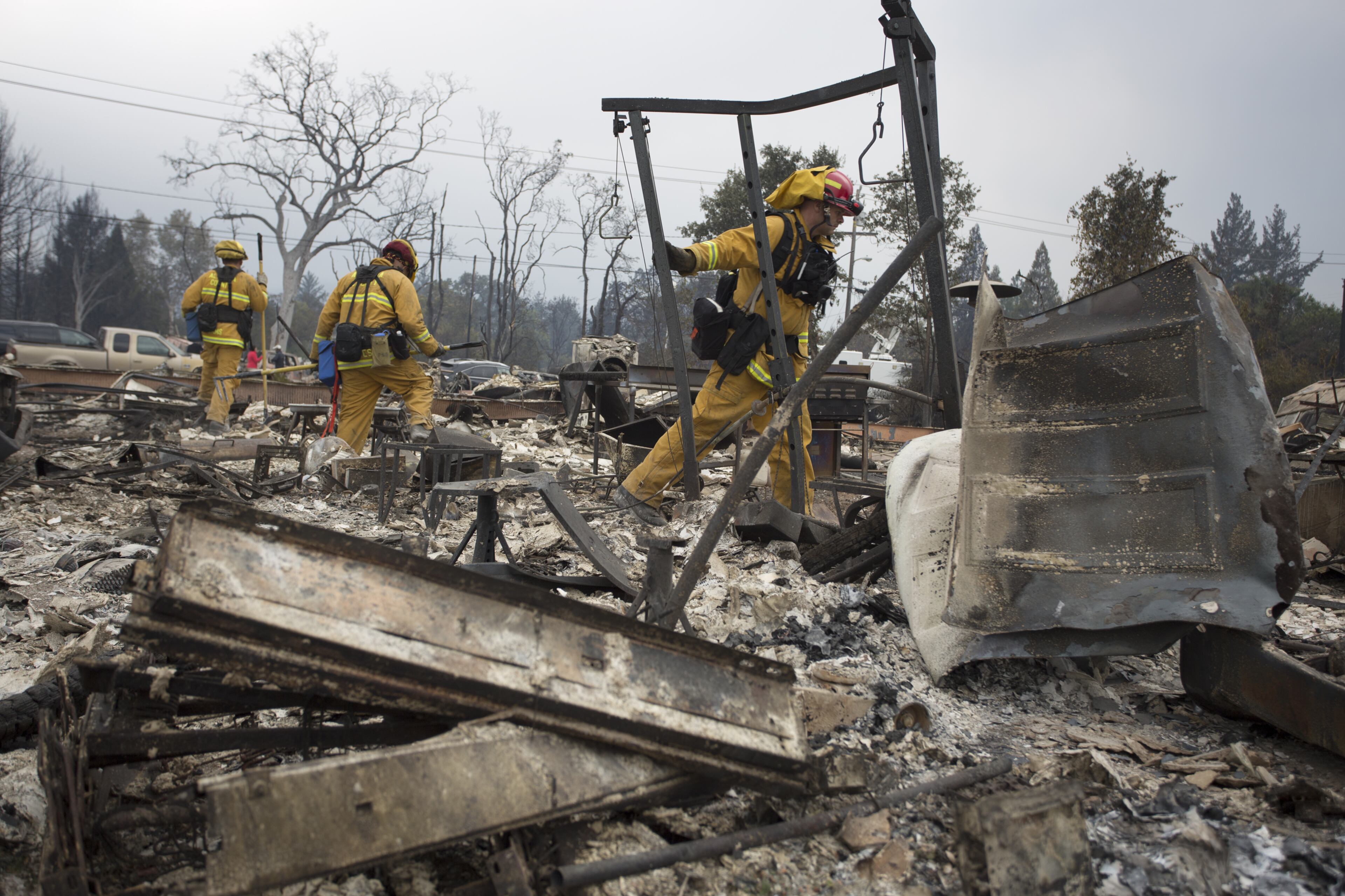 Firefighters look through the ruins of structures burned by the Valley Fire on September 14, 2015 in Middletown, California. The 95-square-mile fire has destroyed hundreds of homes and is only five percent contained. (Photo by David McNew/Getty Images)