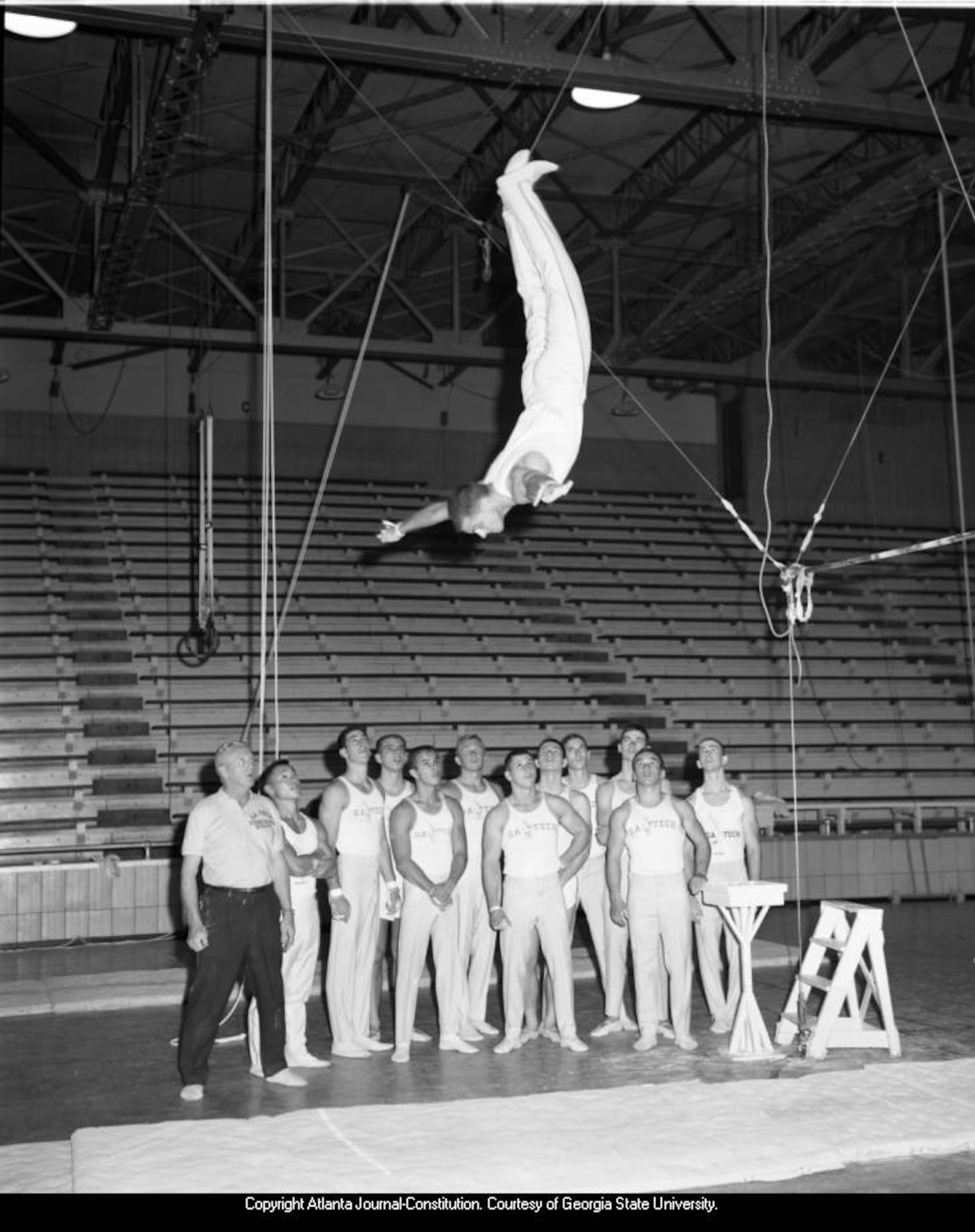 Dec. 6, 1962 -- Georgia Tech gymnastics team captain Joe Gatins dismounts the horizontal bar. FLOYD E. JILLSON / AJC PHOTO ARCHIVES