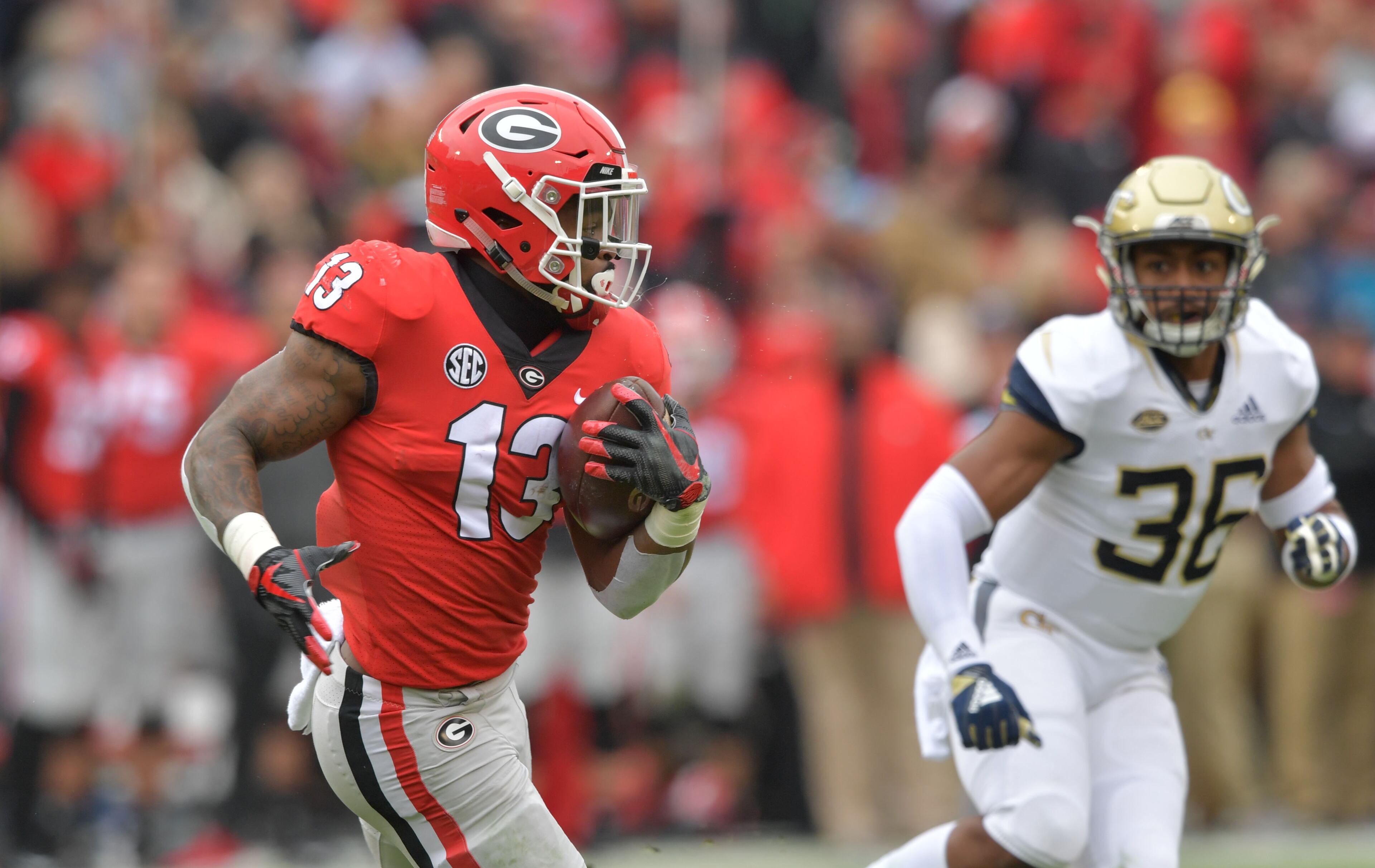 November 24, 2018 Athens - Georgia running back Elijah Holyfield (13) runs with the football during the first half in a NCAA college football game at Sanford Stadium on Saturday, November 24, 2018. Georgia won 45 - 21 over the Georgia Tech. HYOSUB SHIN / HSHIN@AJC.COM