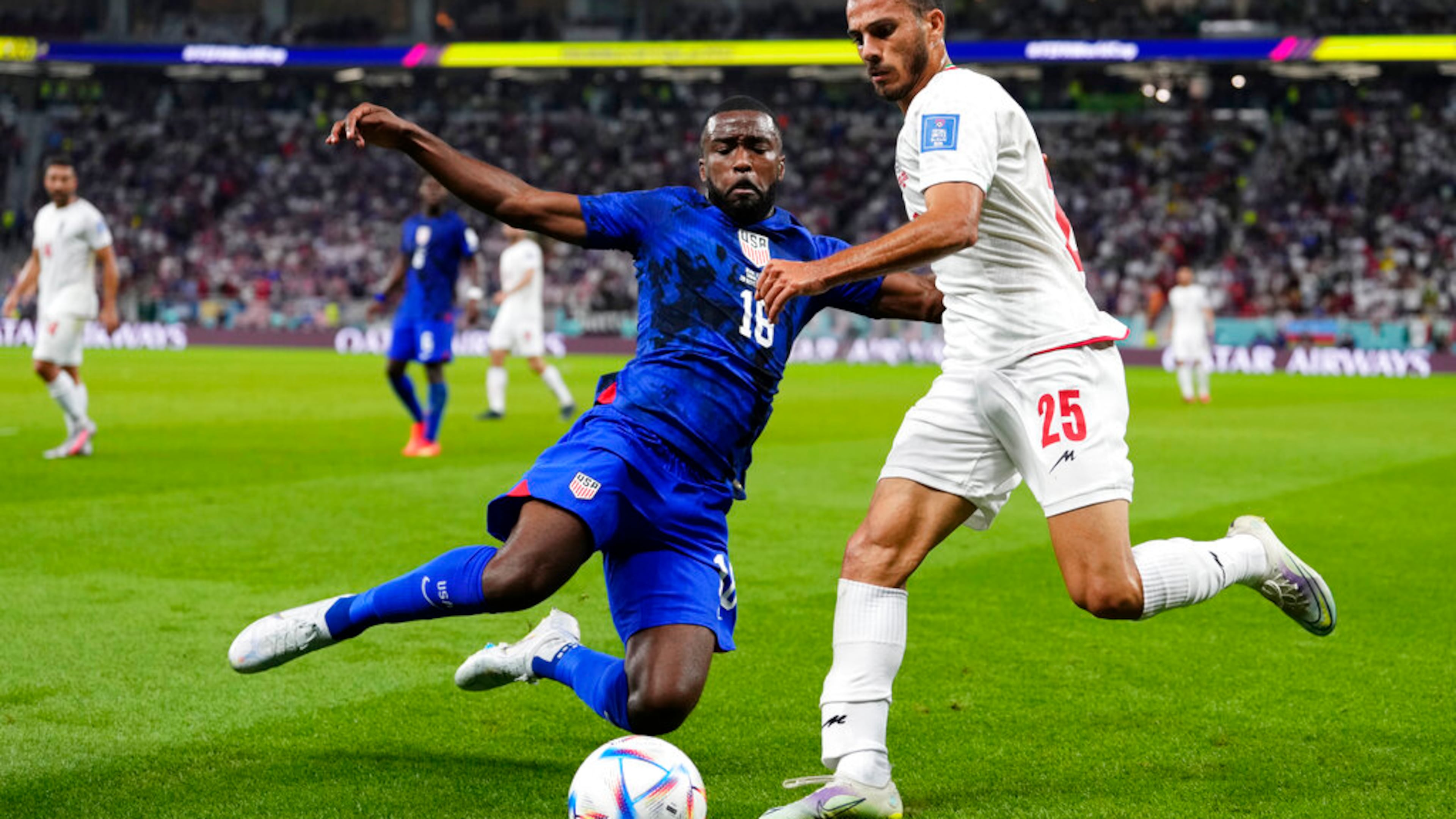 Shaq Moore of the United States (left) challenges Iran's Abolfazl Jalali during the World Cup Group B soccer match between Iran and the U.S. in Doha, Qatar. (Manu Fernandez/AP 2022)