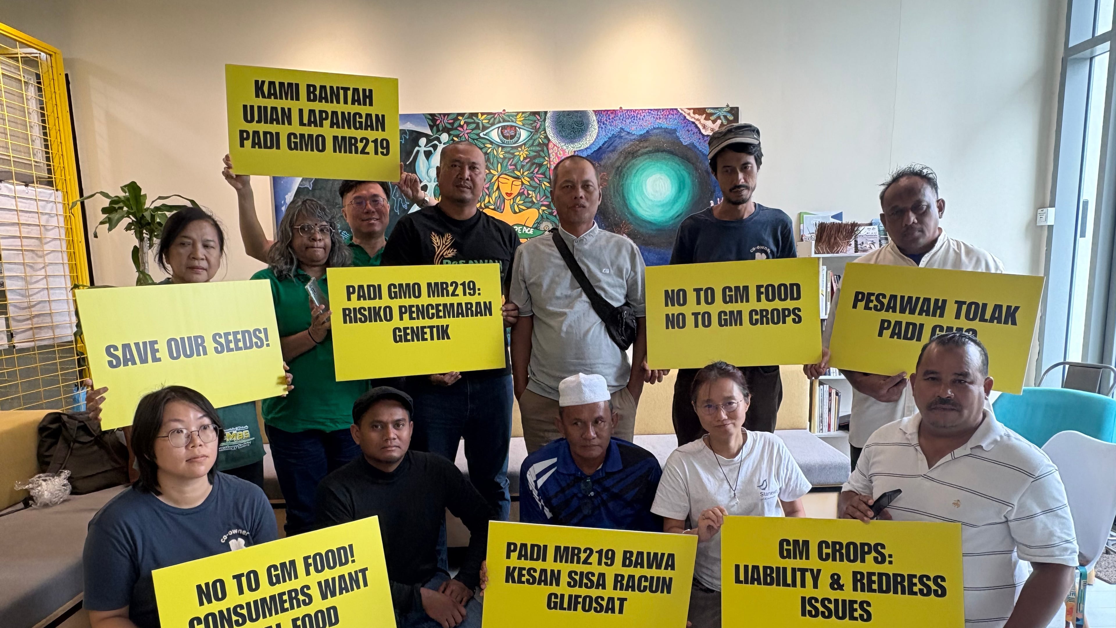 A coalition of farmers, consumer and environmental groups hold placards after a press conference at the Greenpeace office in Kuala Lumpur, Malaysia, Tuesday, Aug. 11, 2026. (AP Photo/Eileen Ng)