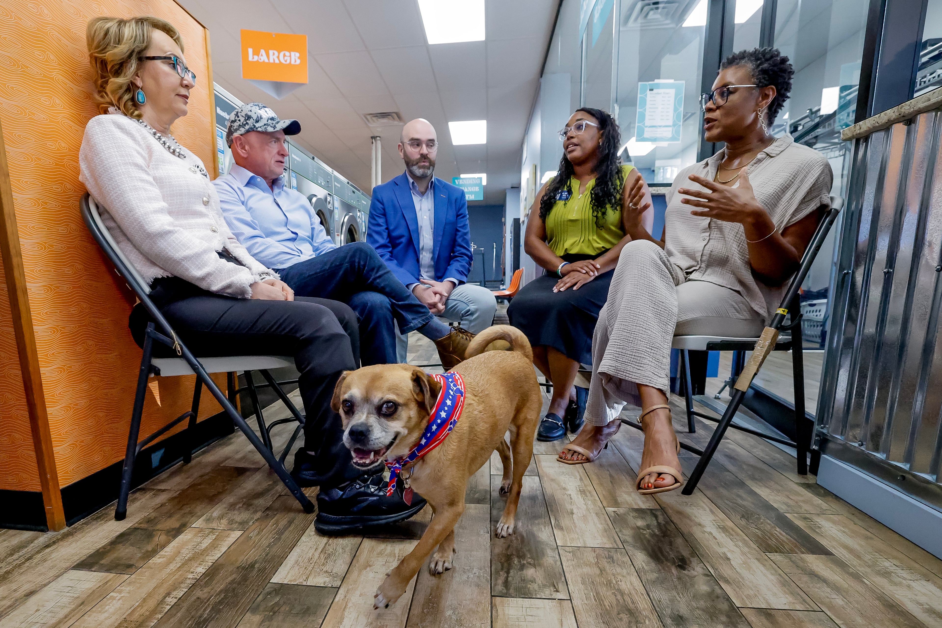 (From left) former Arizona Rep. Gabby Giffords, U.S. Sen. Mark Kelly, Democratic lieutenant governor nominee Josh McLaurin, Sandy Springs councilwoman Melody Kelley and business owner Sherwin Clemons meet during a campaign stop on Wednesday as Foxxie the dog looks at the camera. (Erik S. Lesser for the AJC)