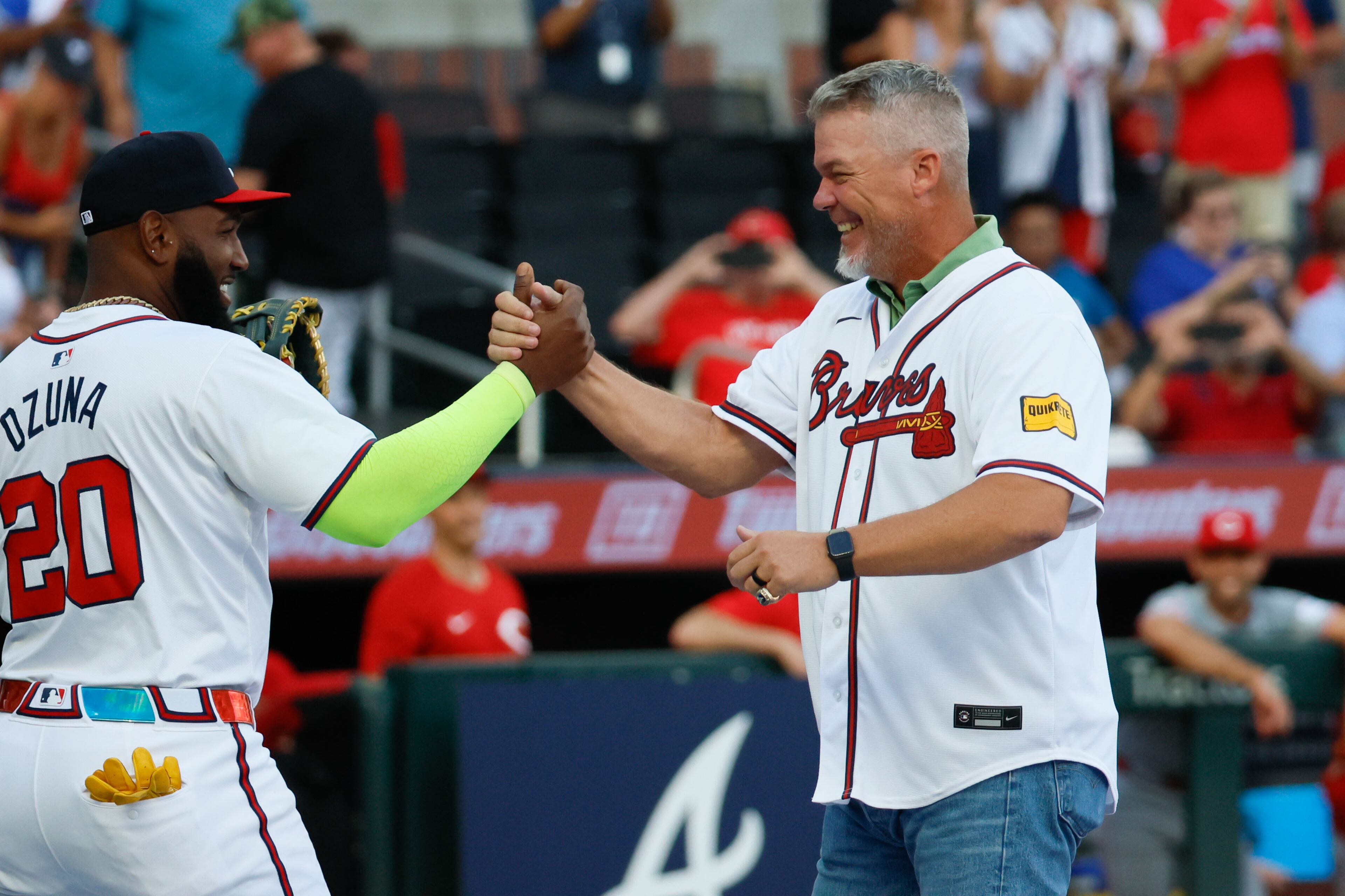 Marcell Ozuna (20) shakes hands with Braves legend and Hall of Famer Chipper Jones after he throws the first pitch at Truist Park on Monday, July 22, 2024, in Atlanta.
(Miguel Martinez/ AJC)