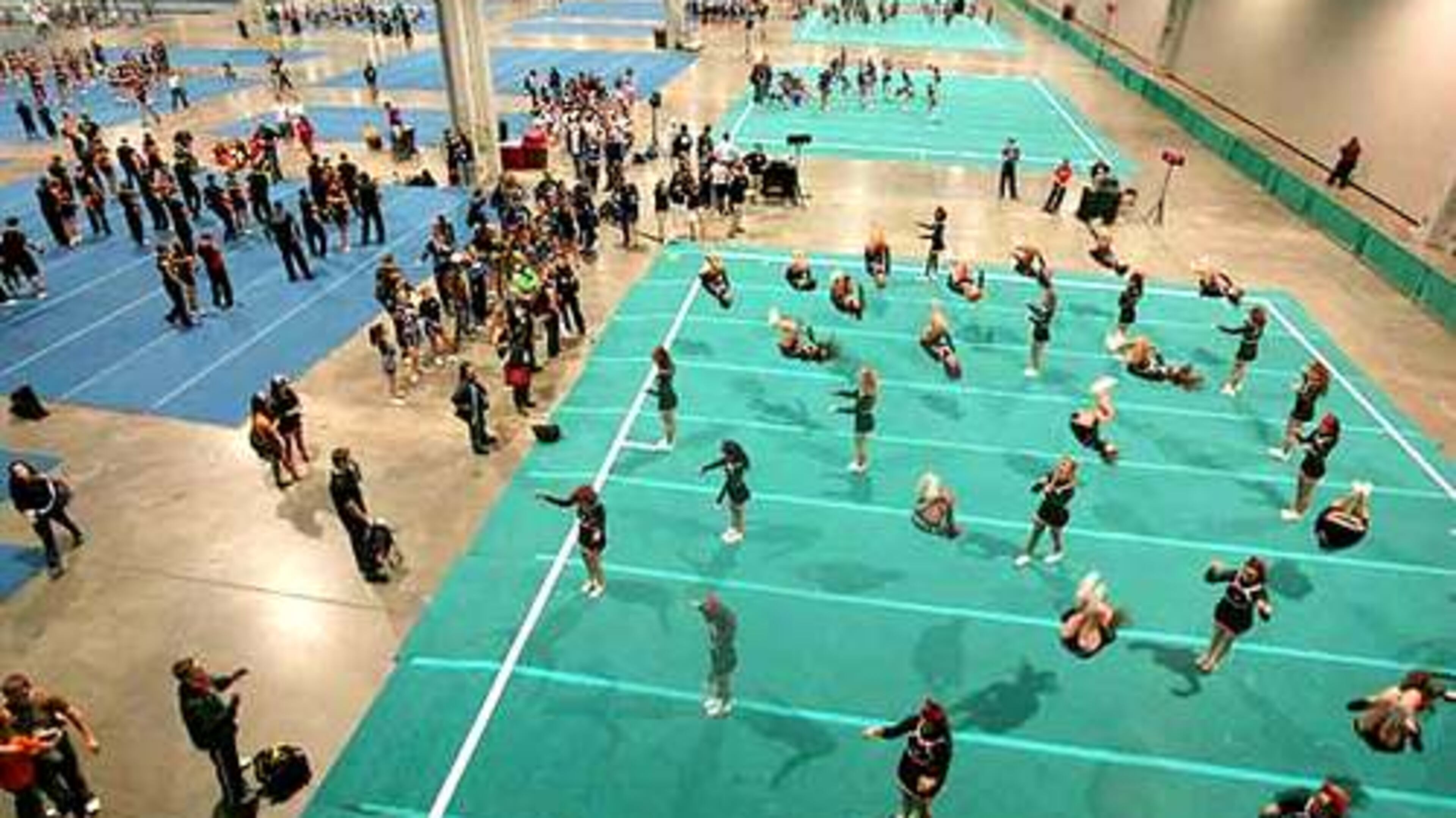 Hundreds of cheerleaders practice in the warm up area. (AJC File photo)