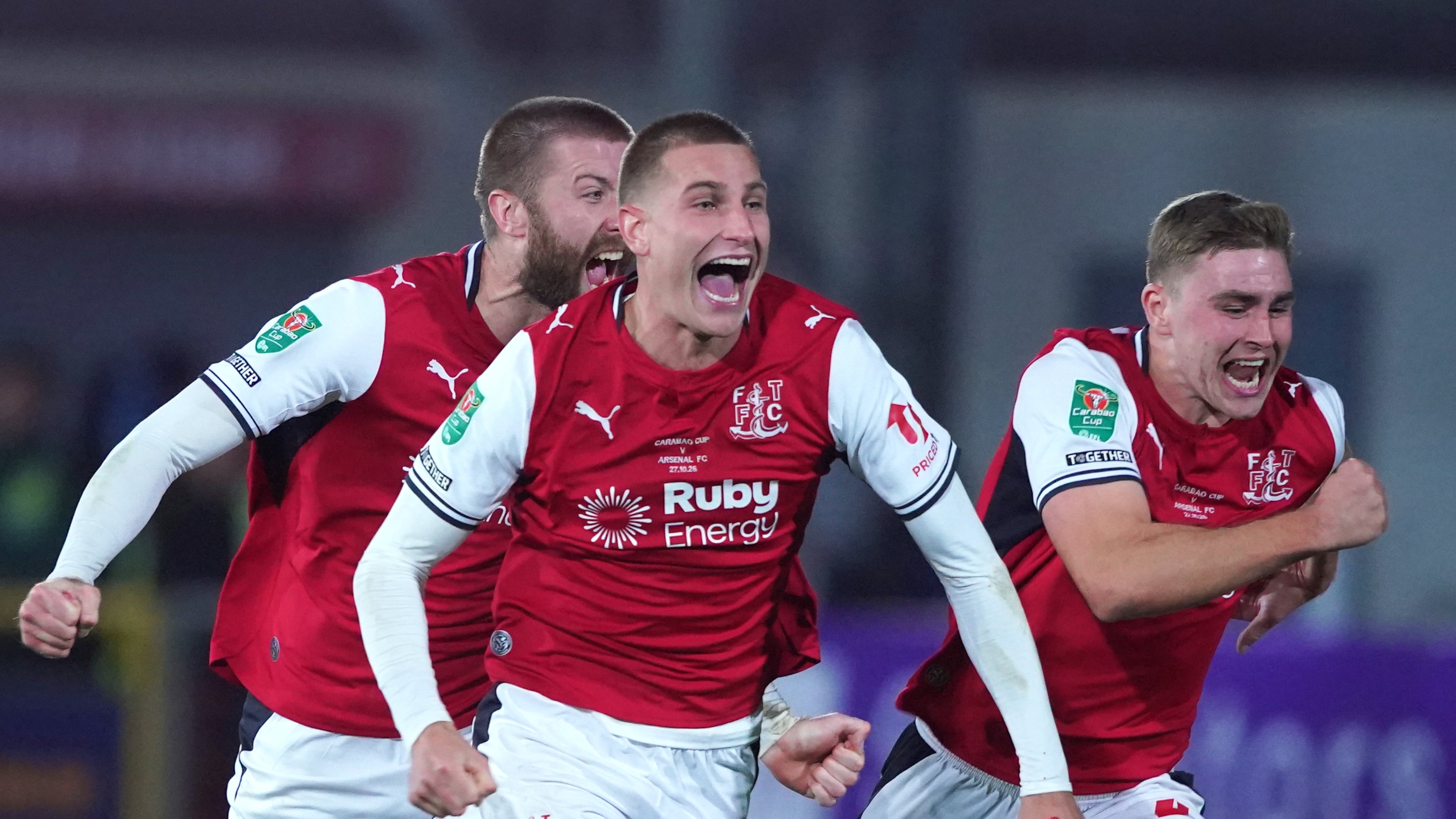 Fleetwood's players celebrate after winning a penalty shootout during the English League Cup soccer match between Fleetwood Town and Arsenal in Fleetwood, England, Tuesday, Oct. 27, 2026. (AP Photo/Ian Hodgson)
