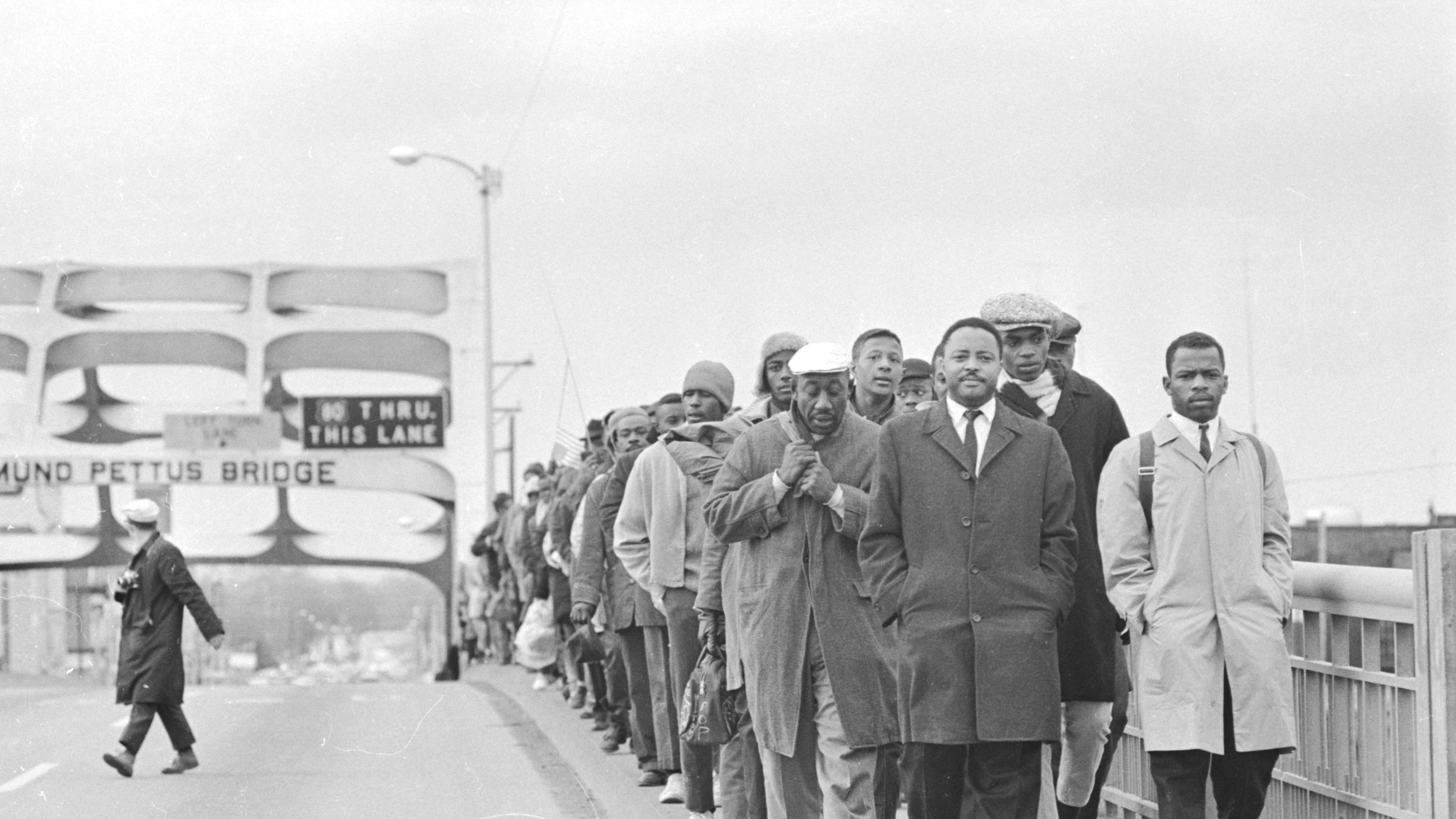 Hosea Williams and John Lewis lead marchers across the Edmund Pettus Bridge in Selma, Alabama, on Bloody Sunday. Robert "Bob" Mants is pictured walking between Williams and Lewis. (Tom Lankford/The Birmingham News via AP)