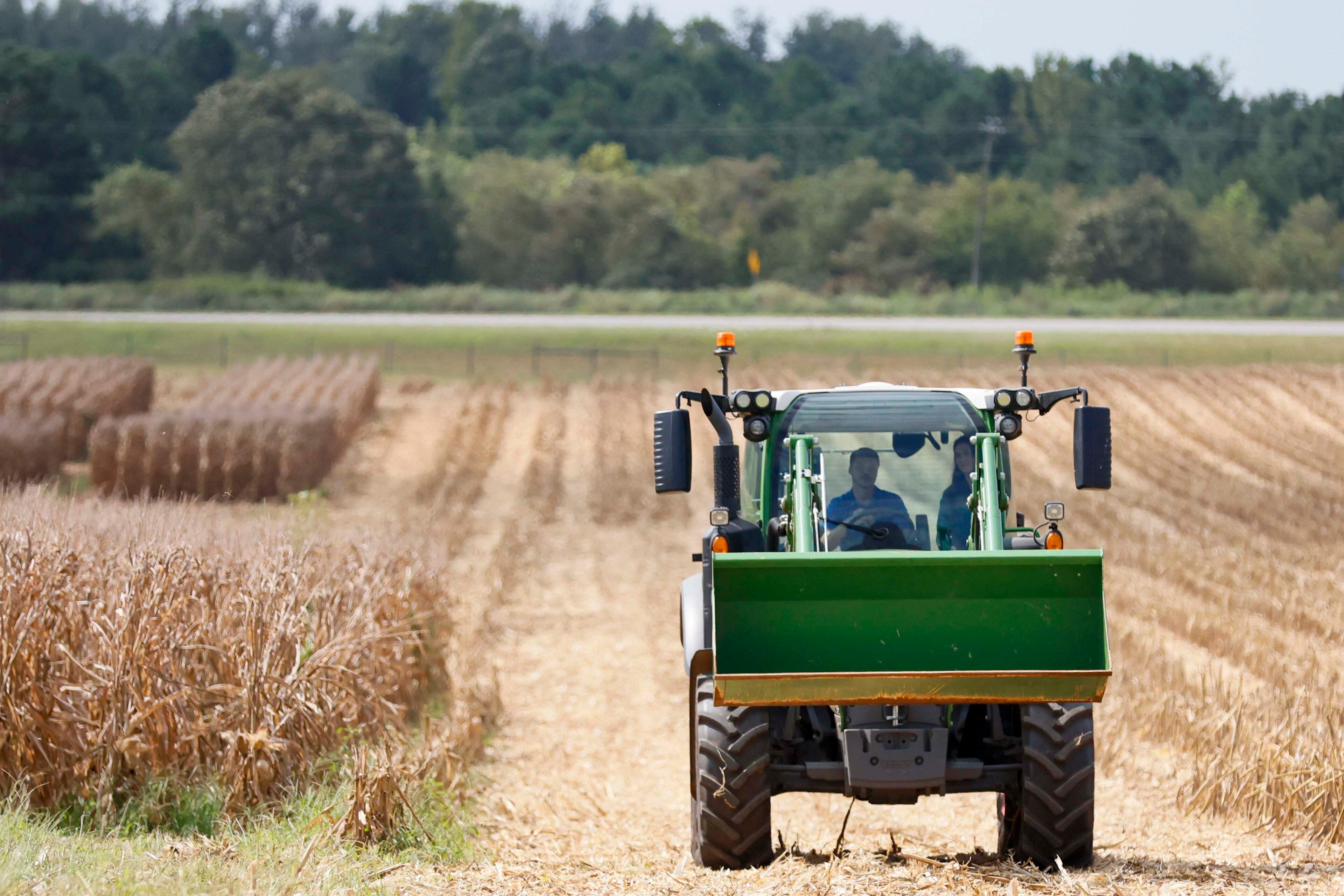A tractor moves beside a corn field at the Iron Horse Plant Sciences Farm with the J. Phil Campbell Sr. Research and Education Center.
(Miguel Martinez/AJC)