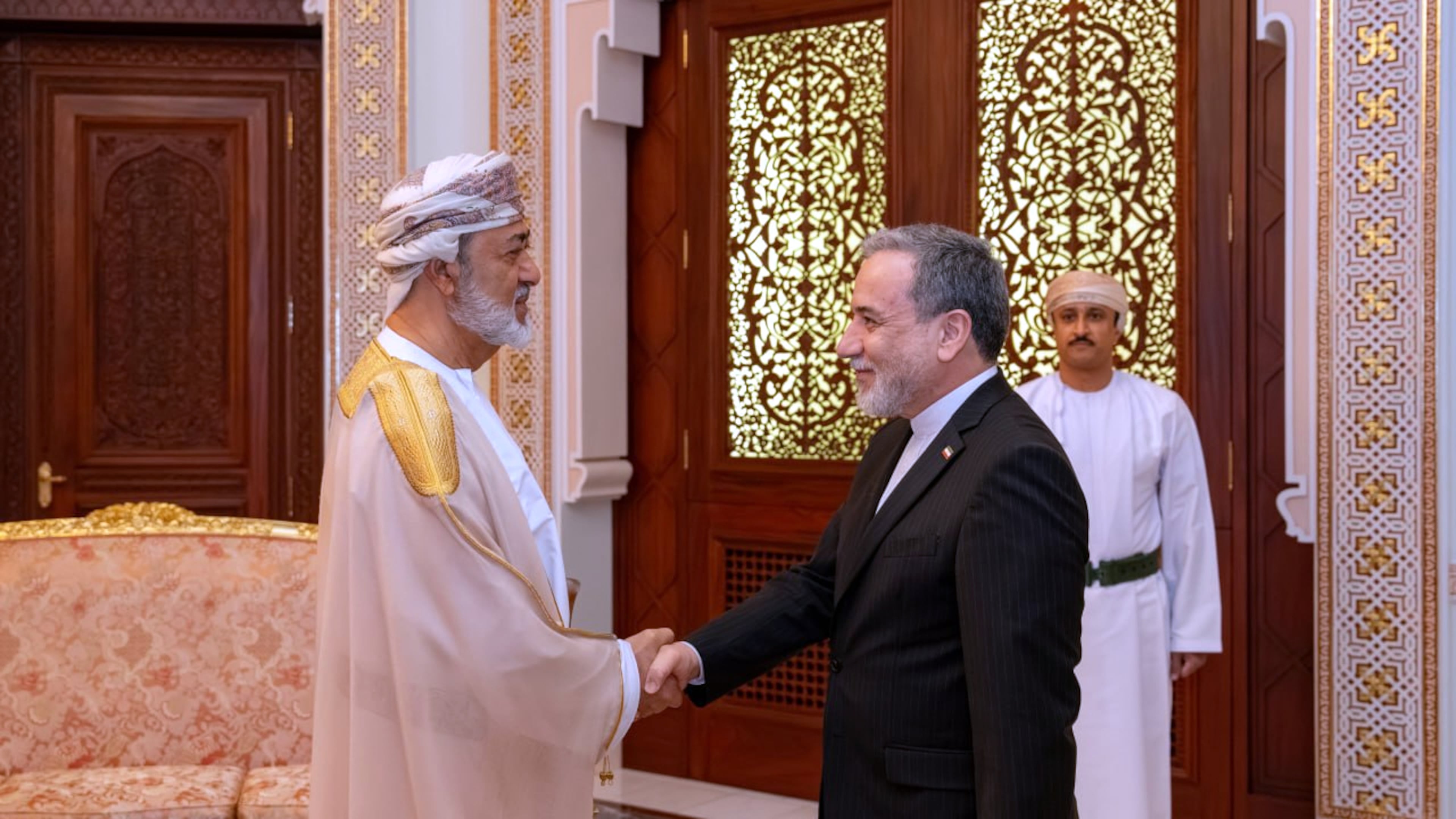 In this photo released by the Iranian Foreign Ministry, Iranian Foreign Minister Abbas Araghchi, right, shakes hands with Oman's Sultan Haitham bin Tariq during their meeting, in Muscat, Oman, Sunday, April 26, 2026. (Iranian Foreign Ministry via AP)