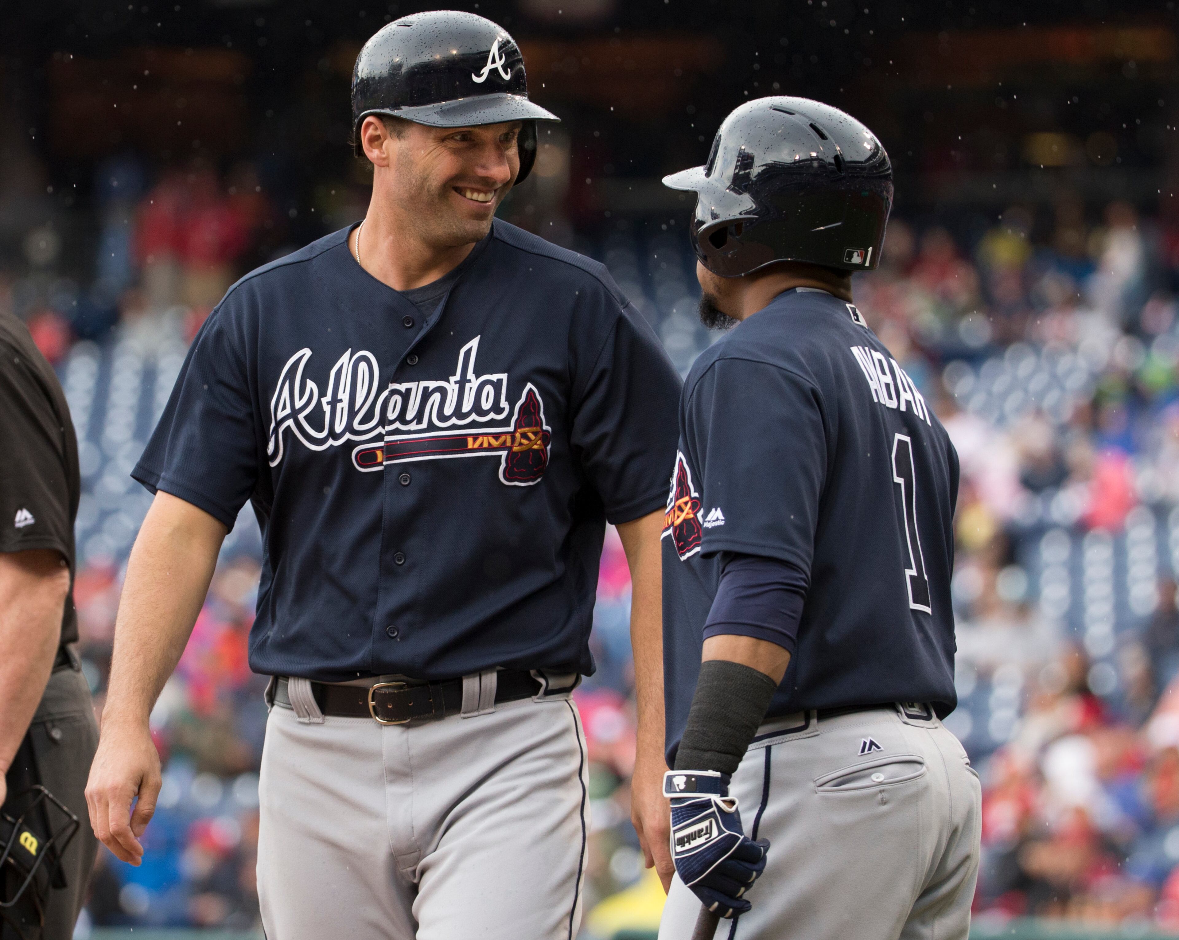 Atlanta Braves' Jeff Francoeur, left, talks with Erick Aybar, right, after scoring a run during the fourth inning of a baseball game against the Philadelphia Phillies, Saturday, May 21, 2016, in Philadelphia. (AP Photo/Chris Szagola)