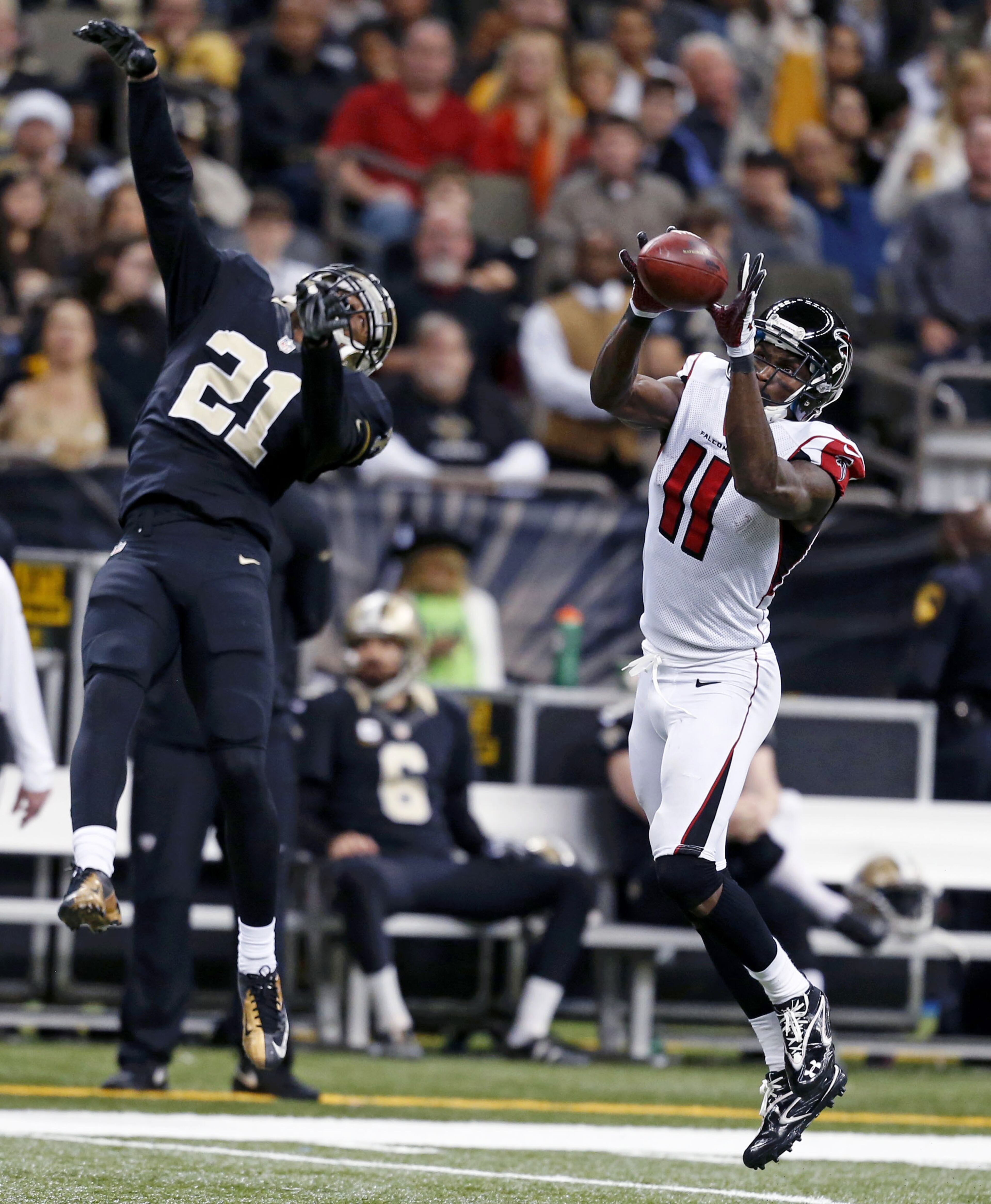 New Orleans Saints cornerback Patrick Robinson (21) leaps to defend a reception by Atlanta Falcons wide receiver Julio Jones (11) in the second half of an NFL football game in New Orleans, Sunday, Dec. 21, 2014. (AP Photo/Rogelio Solis)