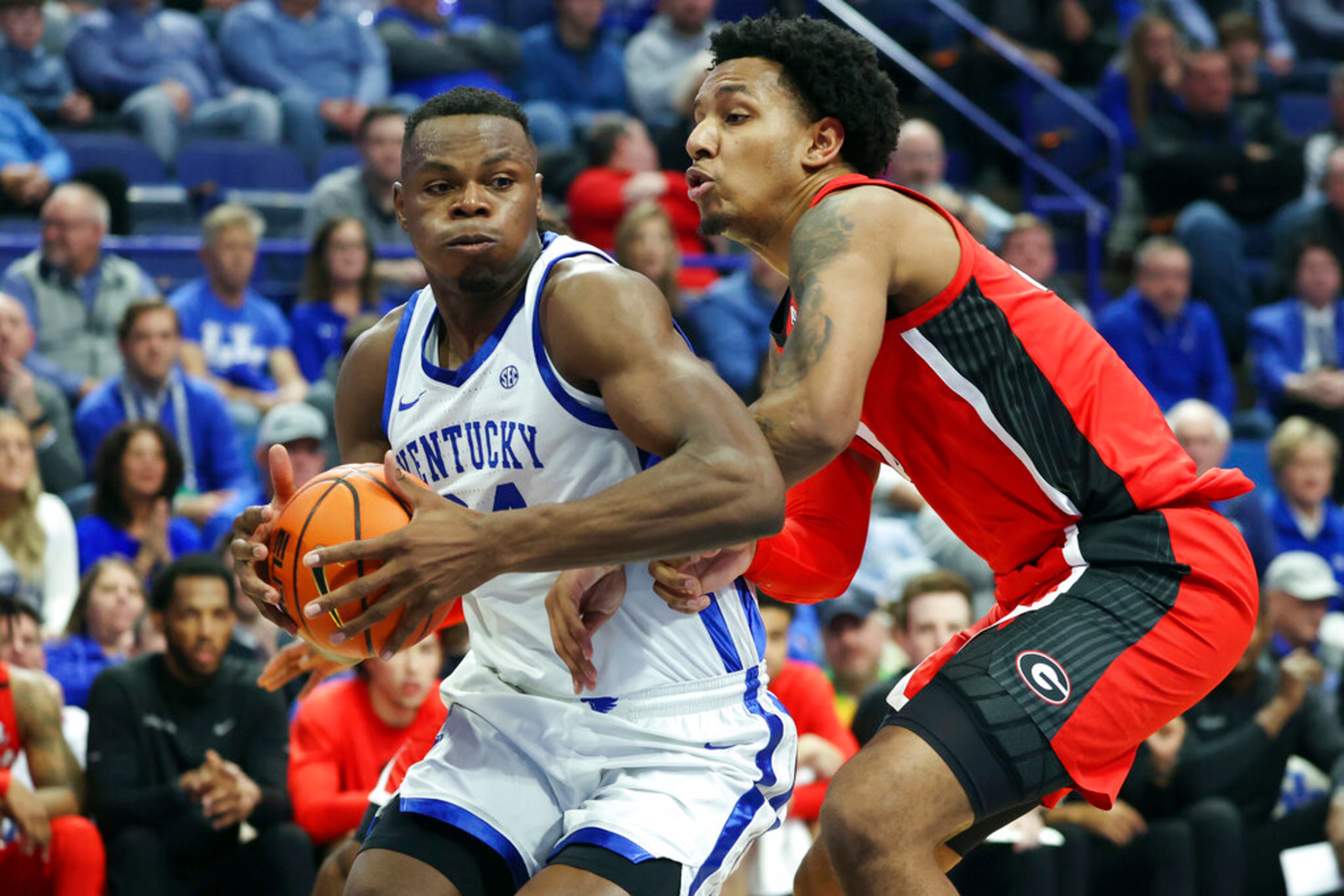 Kentucky's Oscar Tshiebwe, left, looks for an opening on Georgia's Braelen Bridges (23) during the first half of an NCAA college basketball game in Lexington, Ky., Tuesday, Jan. 17, 2023. (AP Photo/James Crisp)