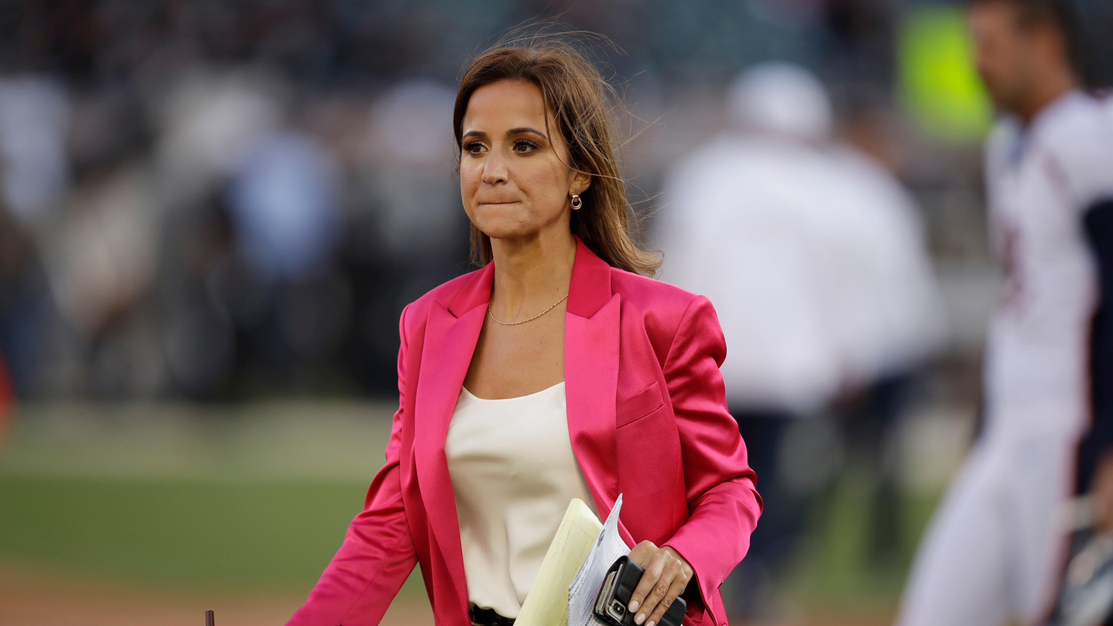 FILE - ESPN reporter Dianna Russini stands on the sidelines before the start of an NFL football game between the Oakland Raiders and the Denver Broncos on Sept. 9, 2019, in Oakland, Calif. (AP Photo/Ben Margot, File)