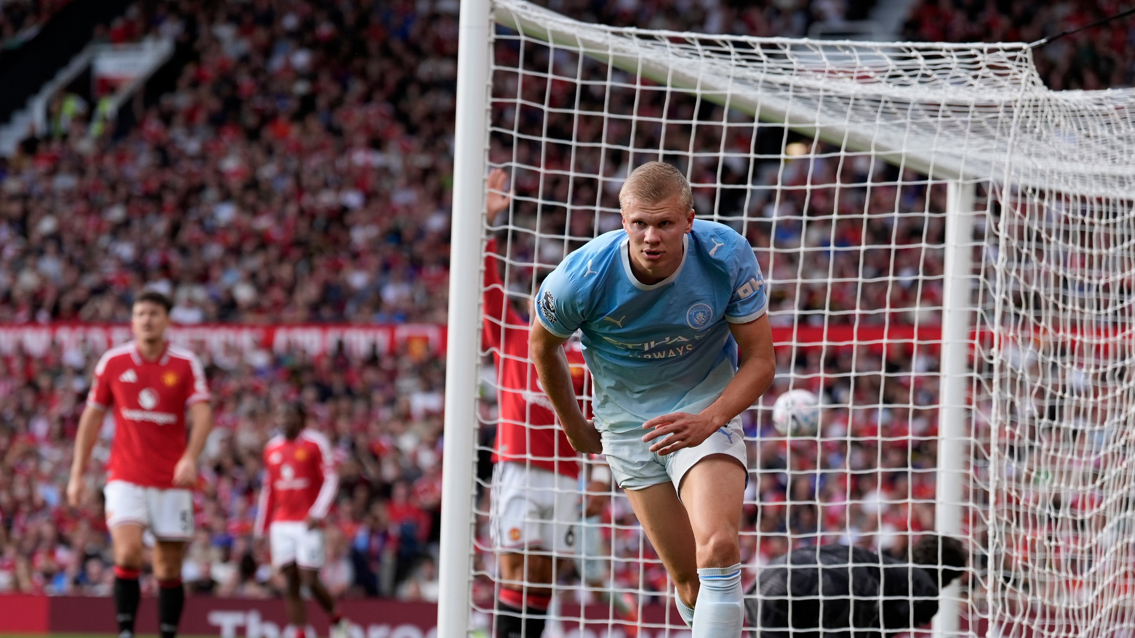 Manchester City's Erling Haaland celebrates after scoring his sides first goal during the English Premier League soccer match against Manchester United in Manchester, England, Sunday Sept. 13, 2026. (Peter Byrne/PA via AP)