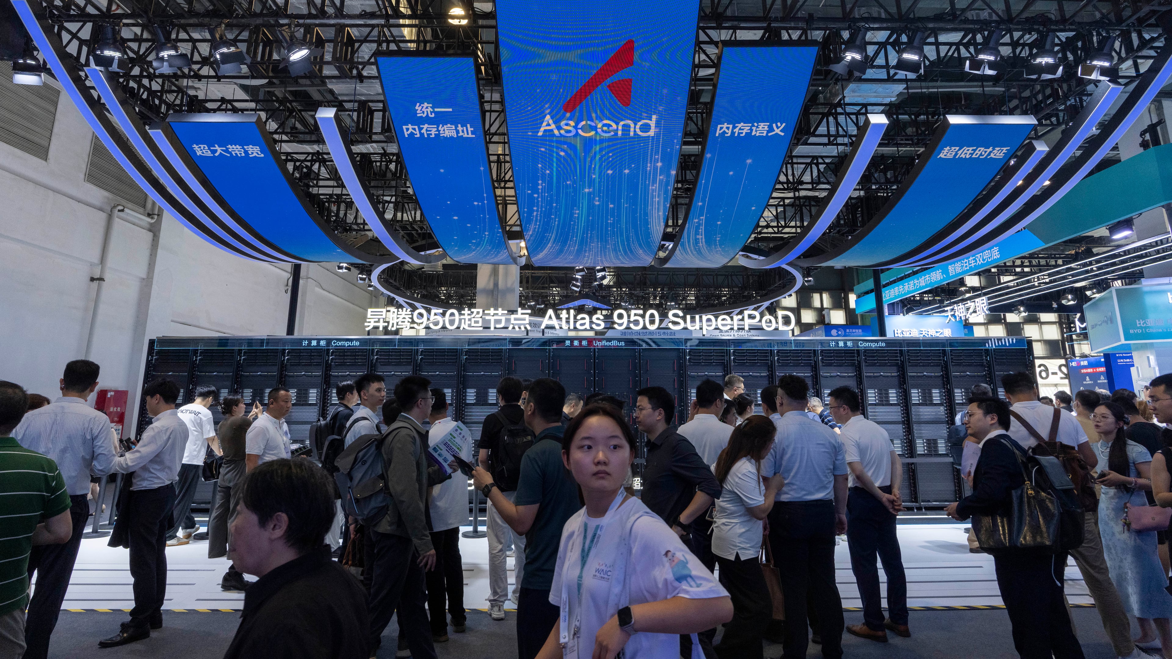 Visitors past by the Huawei booth display of the Atlas 950 SuperPoD during the World AI Conference in Shanghai, China on Friday, July 17, 2026. (AP Photo/Ng Han Guan)