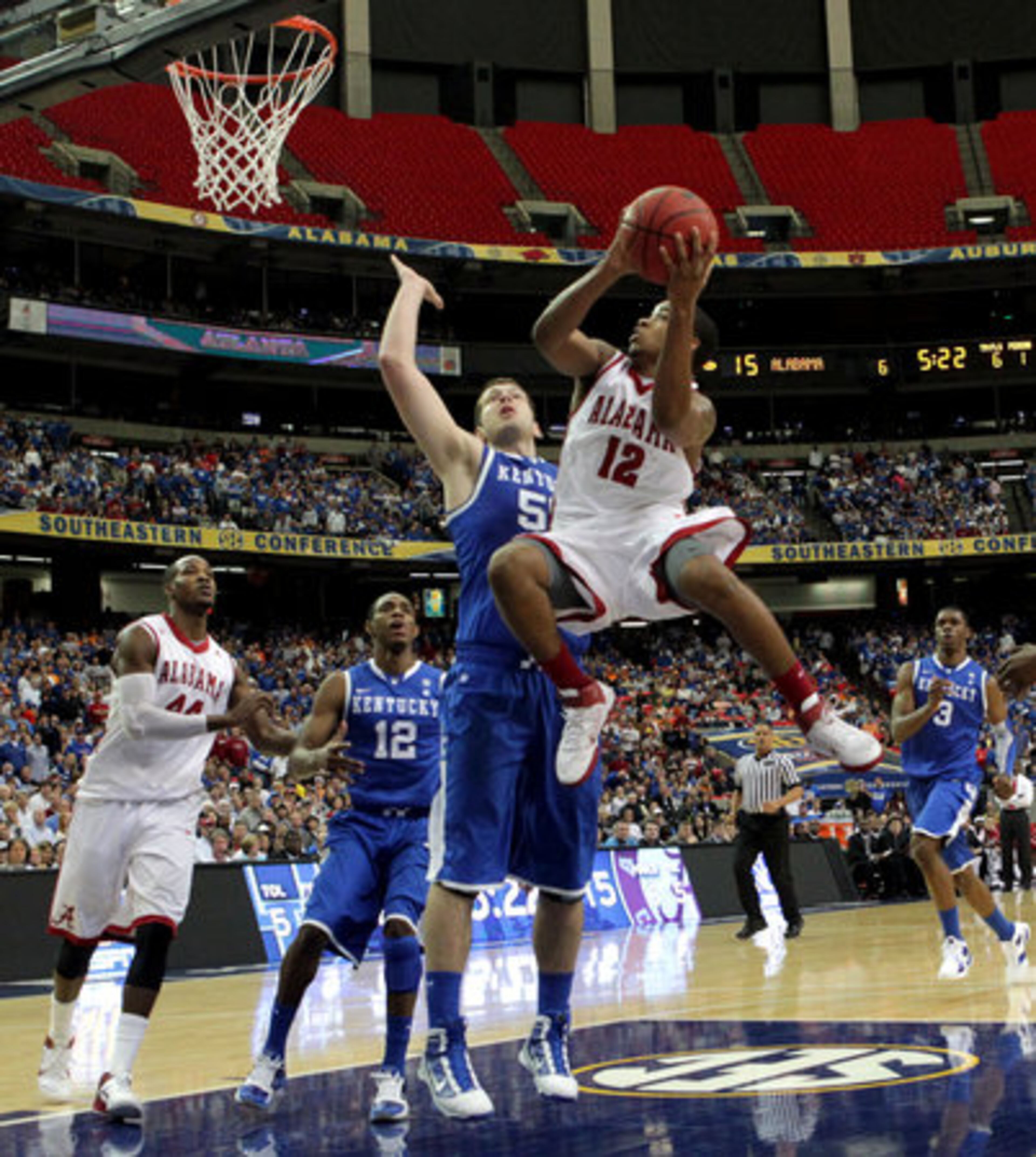 Alabama's Trevor Releford (12) attempts a shot over Kentucky's Josh Harrellson.