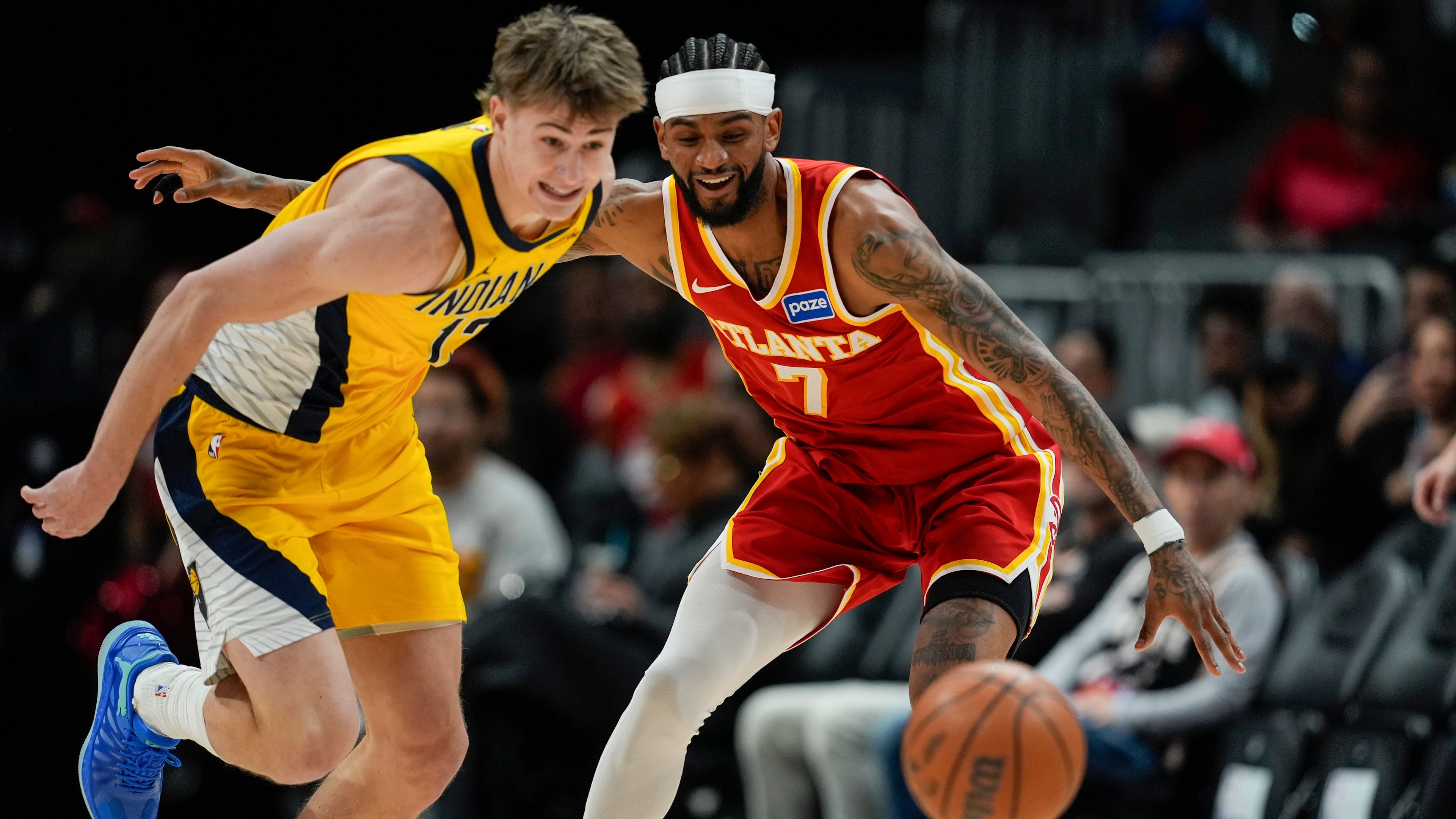 Pacers guard Johnny Furphy (left) and Hawks guard Nickeil Alexander-Walker chase a loose ball during the first half Monday, Jan. 26, 2026, in Atlanta. (Mike Stewart/AP)