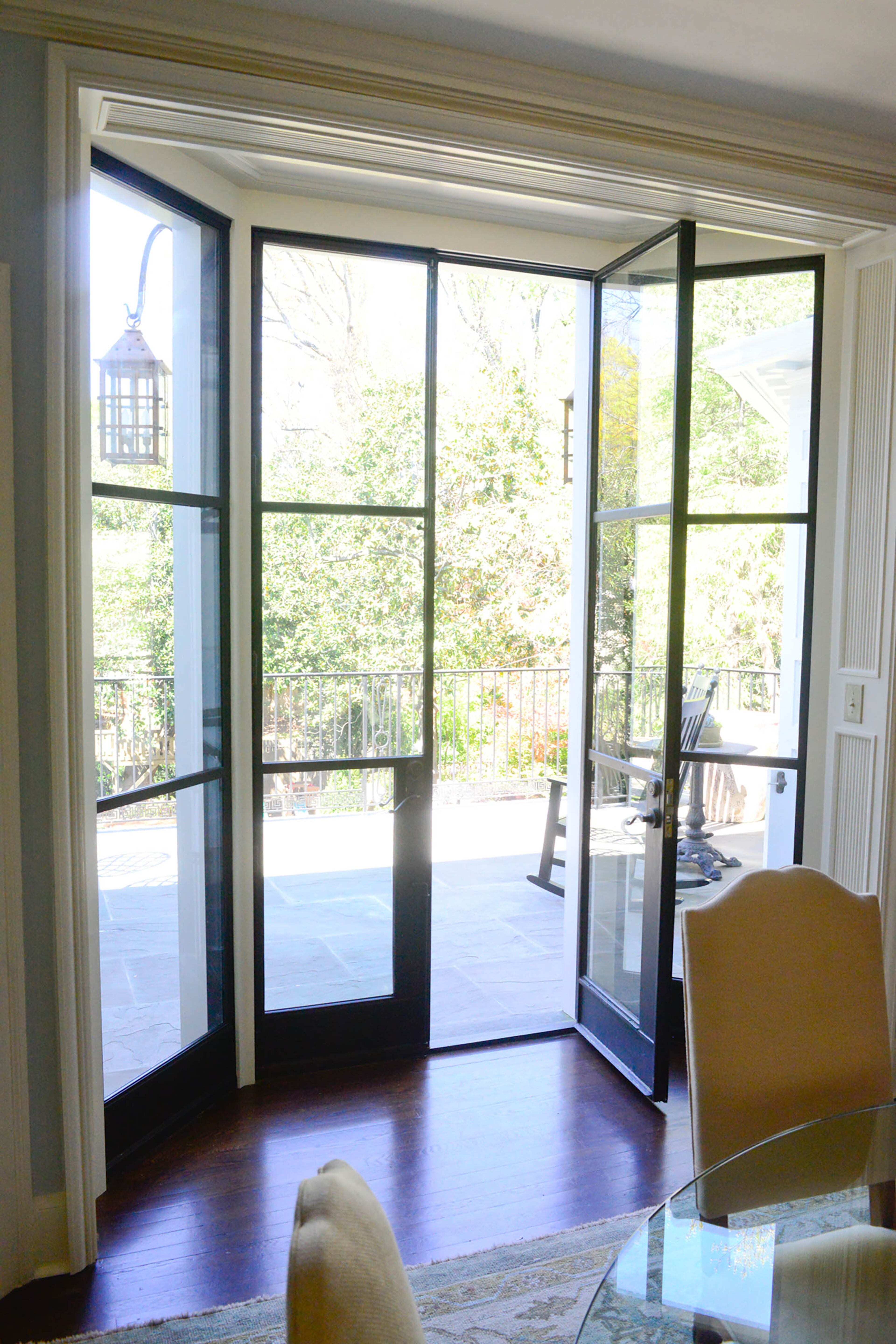 Atlanta architect Norman D. Askins replaced a bay window in the dining room with iron doors that open onto the new terrace. Neal Gasaway Homes was the contractor for the renovations in 2015.