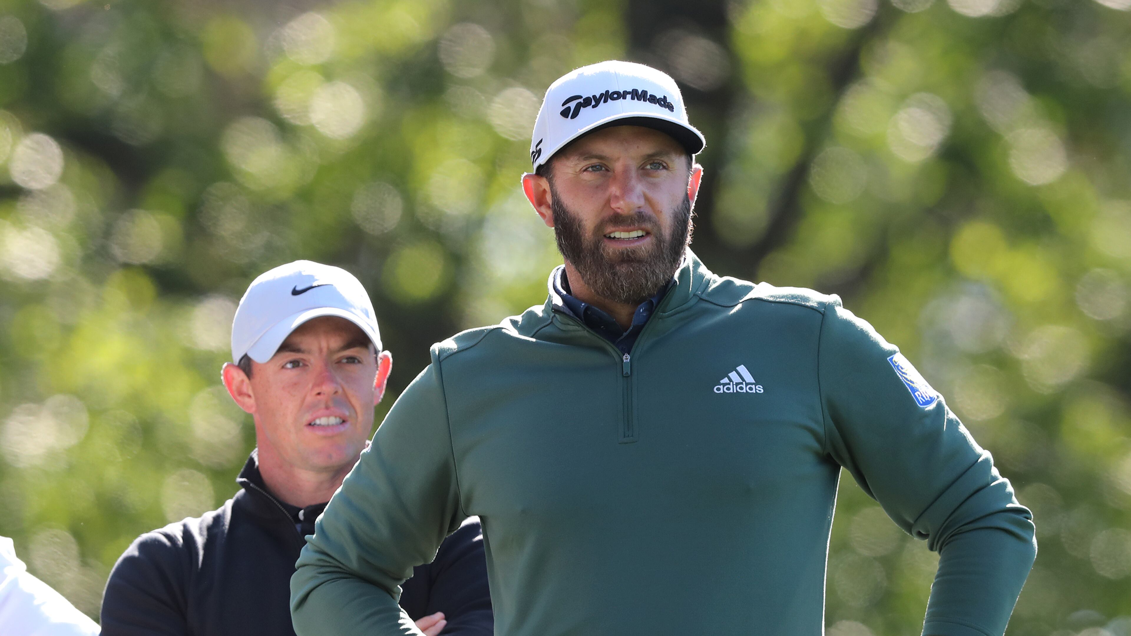 Rory McIIroy (left) and Dustin Johnson prepare to tee off on the fourth hole during their practice round for the Masters at Augusta National Golf Club on Monday, April 5, 2021, in Augusta. Curtis Compton / Curtis.Compton@ajc.com