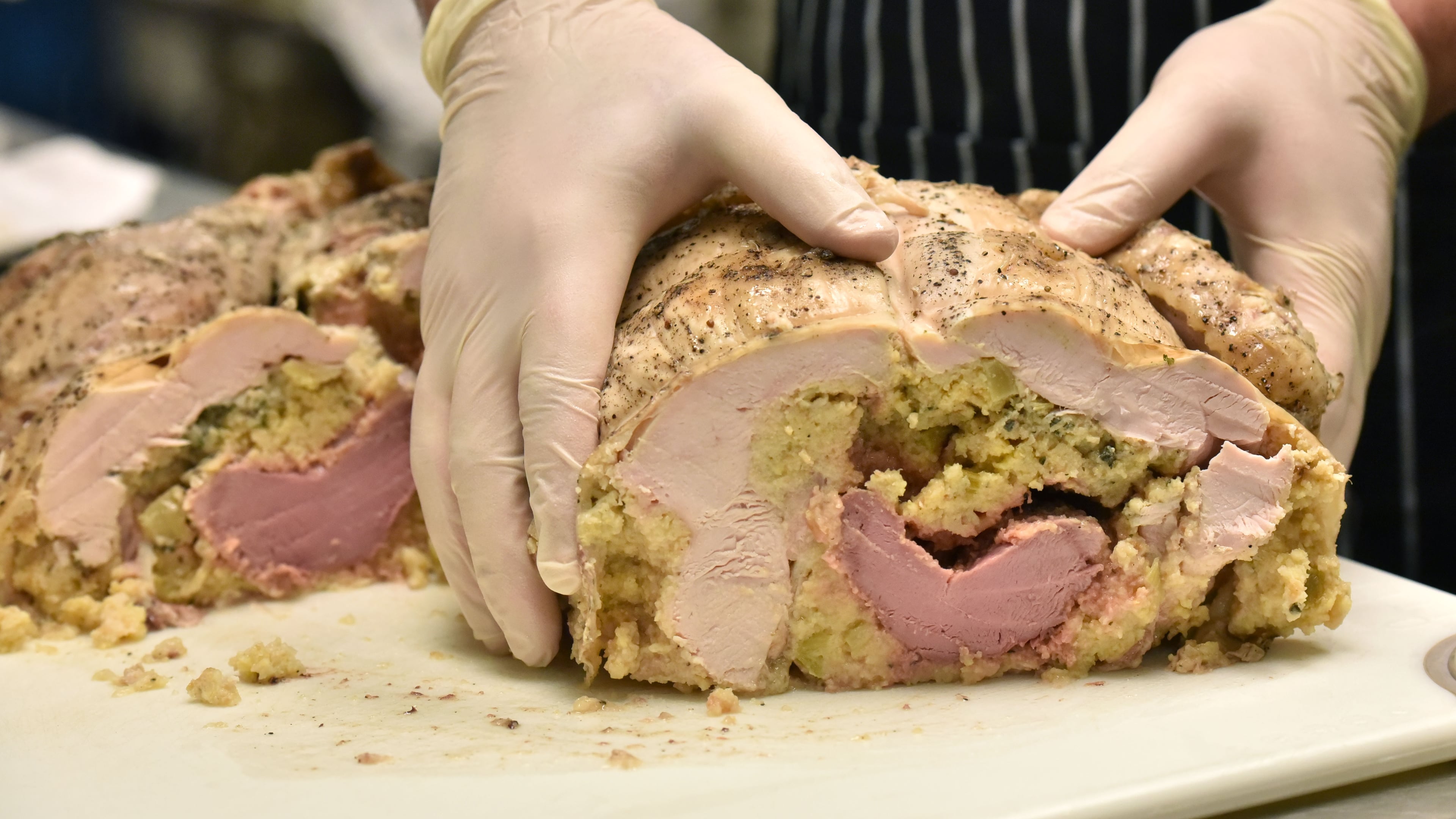 Executive Chef Keegan Hughes shows a cooked Turducken at The Peach and the Porkchopin Roswell. / HYOSUB SHIN / HSHIN@AJC.COM