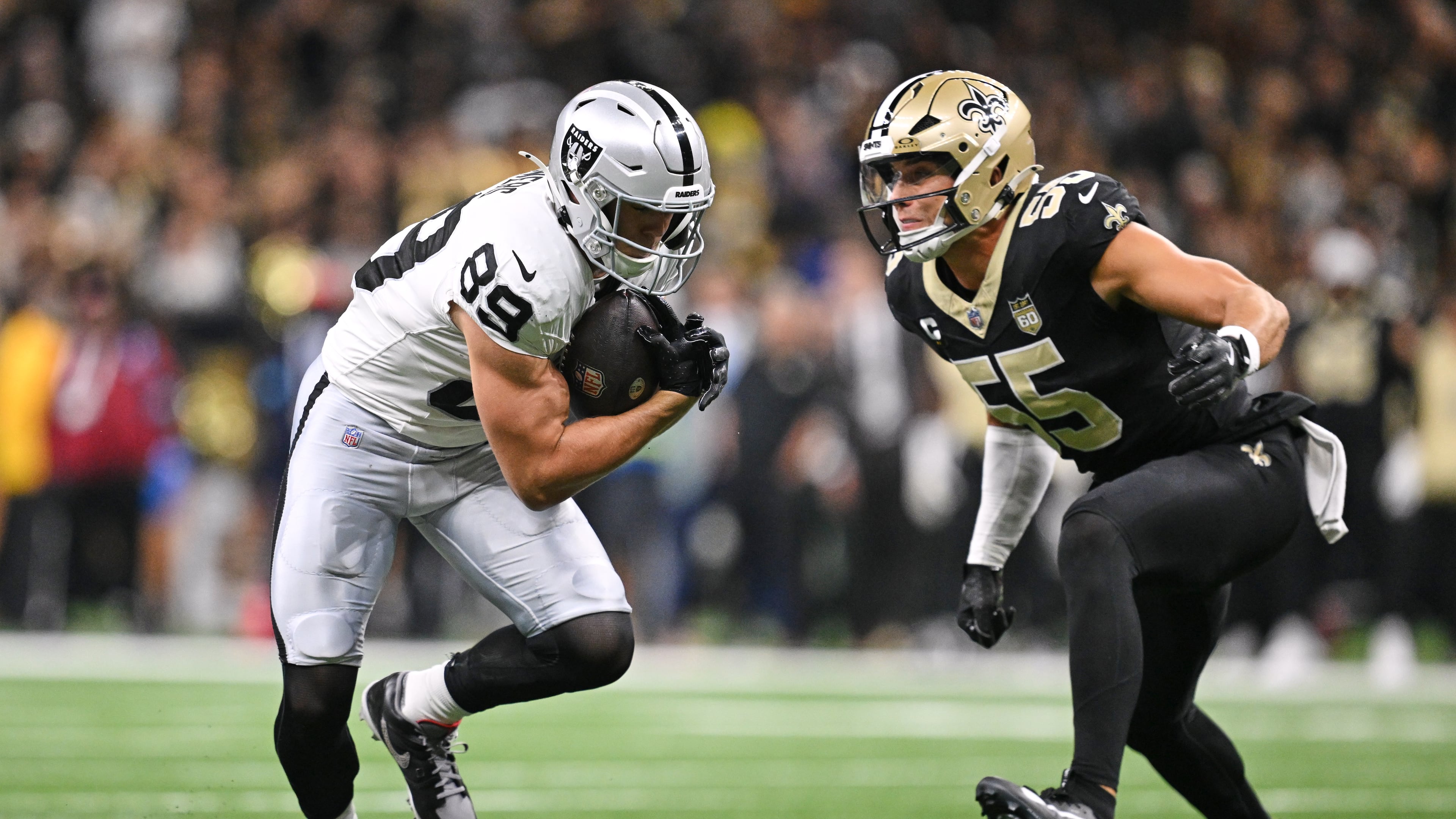 Raiders tight end Brock Bowers (left) gains yards after a catch as Saints linebacker Kaden Elliss closes in to make the stop during the first half in New Orleans on Sunday, Sept. 27, 2026. (Ella Hall/AP)