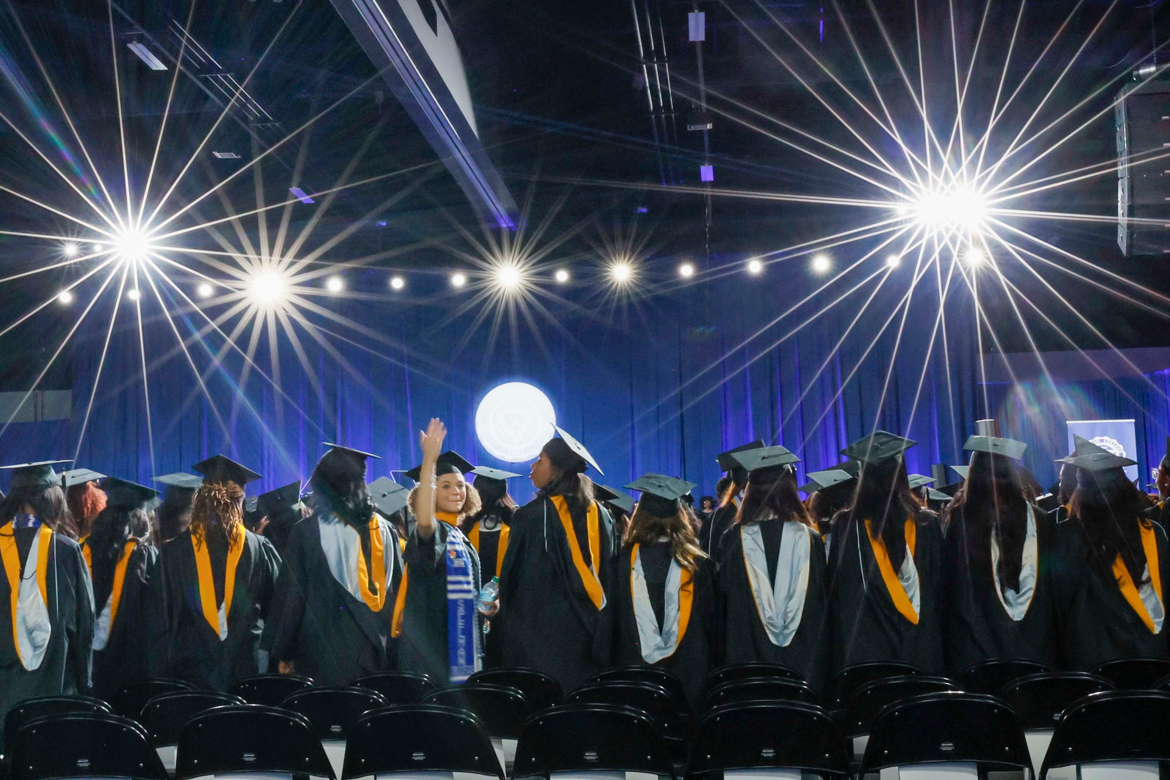 A graduate turned to wave to family and friends in the audience during the Spelman College Commencement ceremony at the Georgia International Convention Center in College Park on Sunday, May 17, 2026.
(Miguel Martinez/AJC)