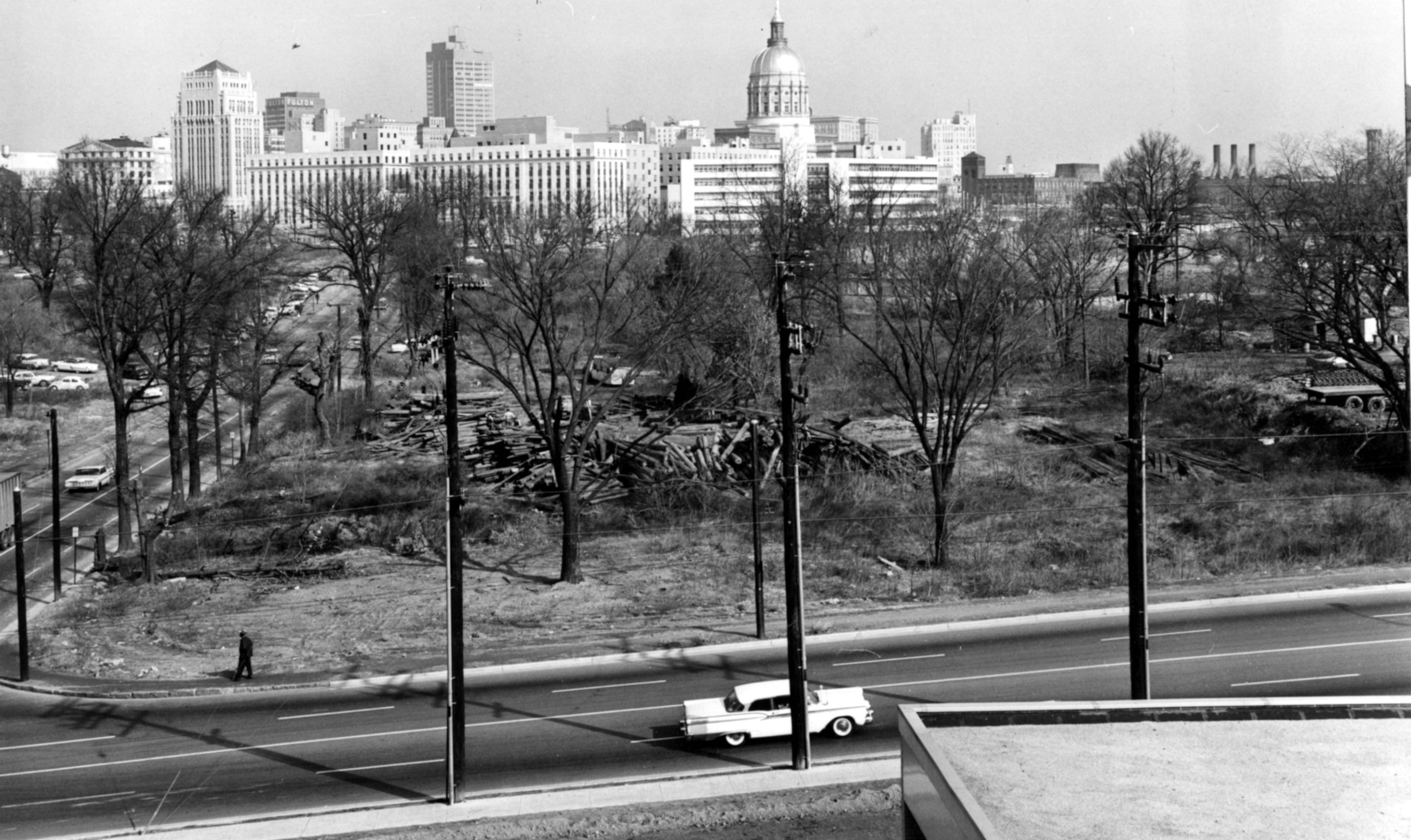 Feb. 1961 - Atlanta, Ga.: - (One of three photos) - This area will accommodate interchange of traffic flowing to and around Atlanta, which rears in skyline profile over brances of bare trees. (Area to become I-20 West) Foreground is Capitol Avenue Bypass.