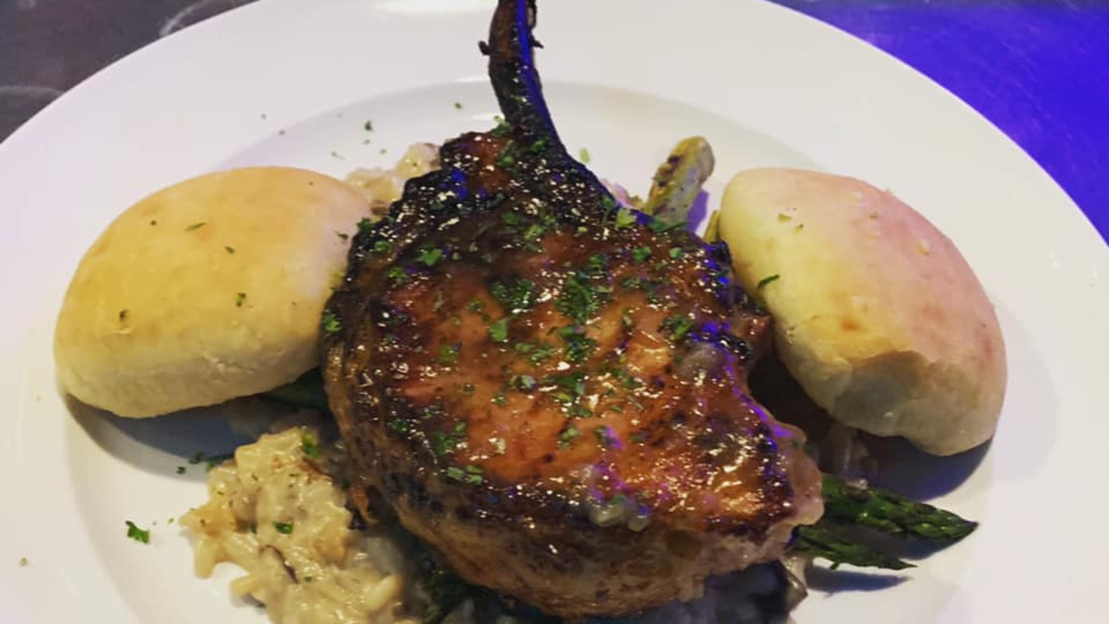 Tomahawk pork chop with apple glaze over mushroom risotto from T-Ray's Fire Grill