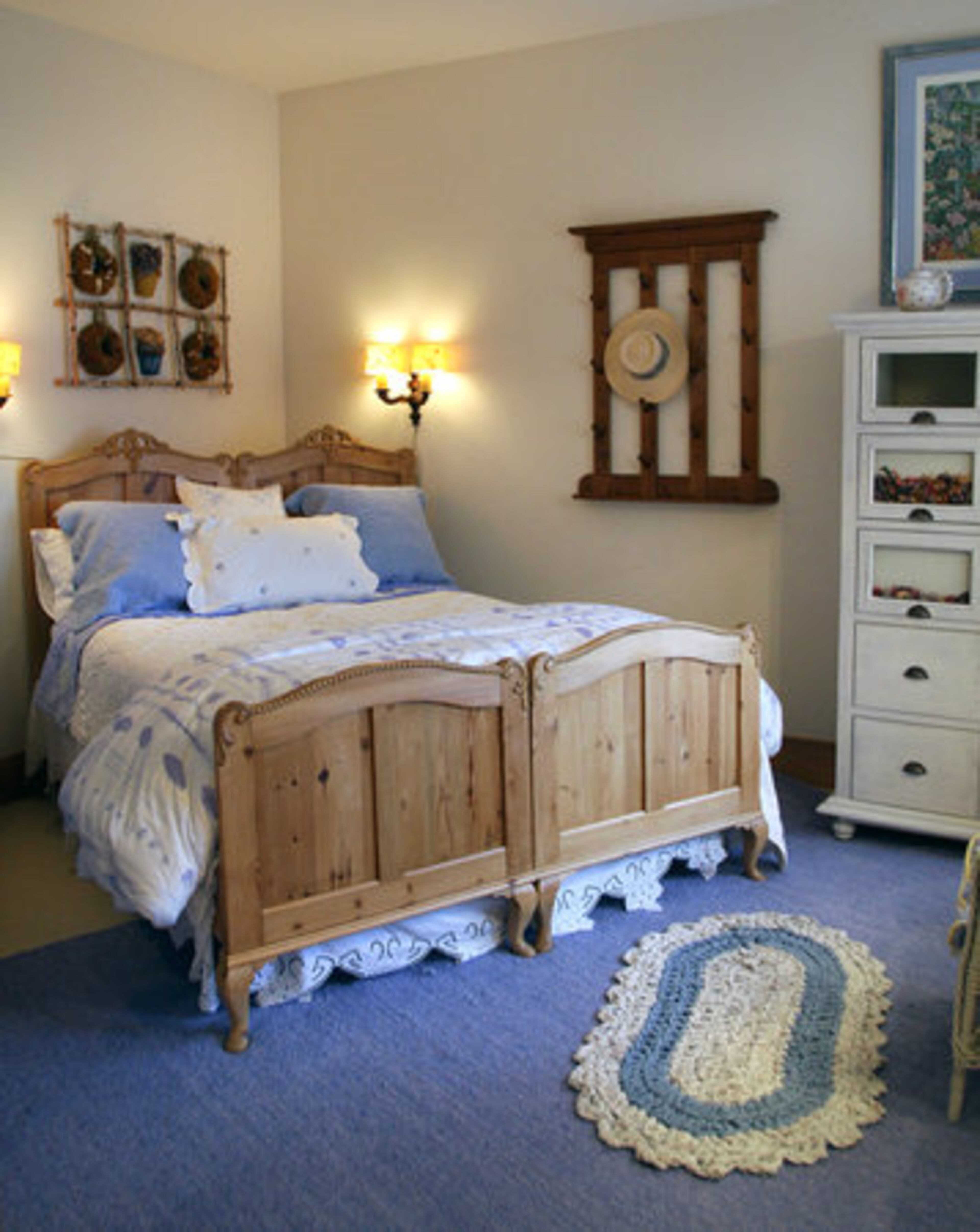 One of the guest bedrooms is done is blue-and-white tones. The bed is two Danish twin beds pushed together. Joan Prater included a sink in the room, as is customary in Europe.