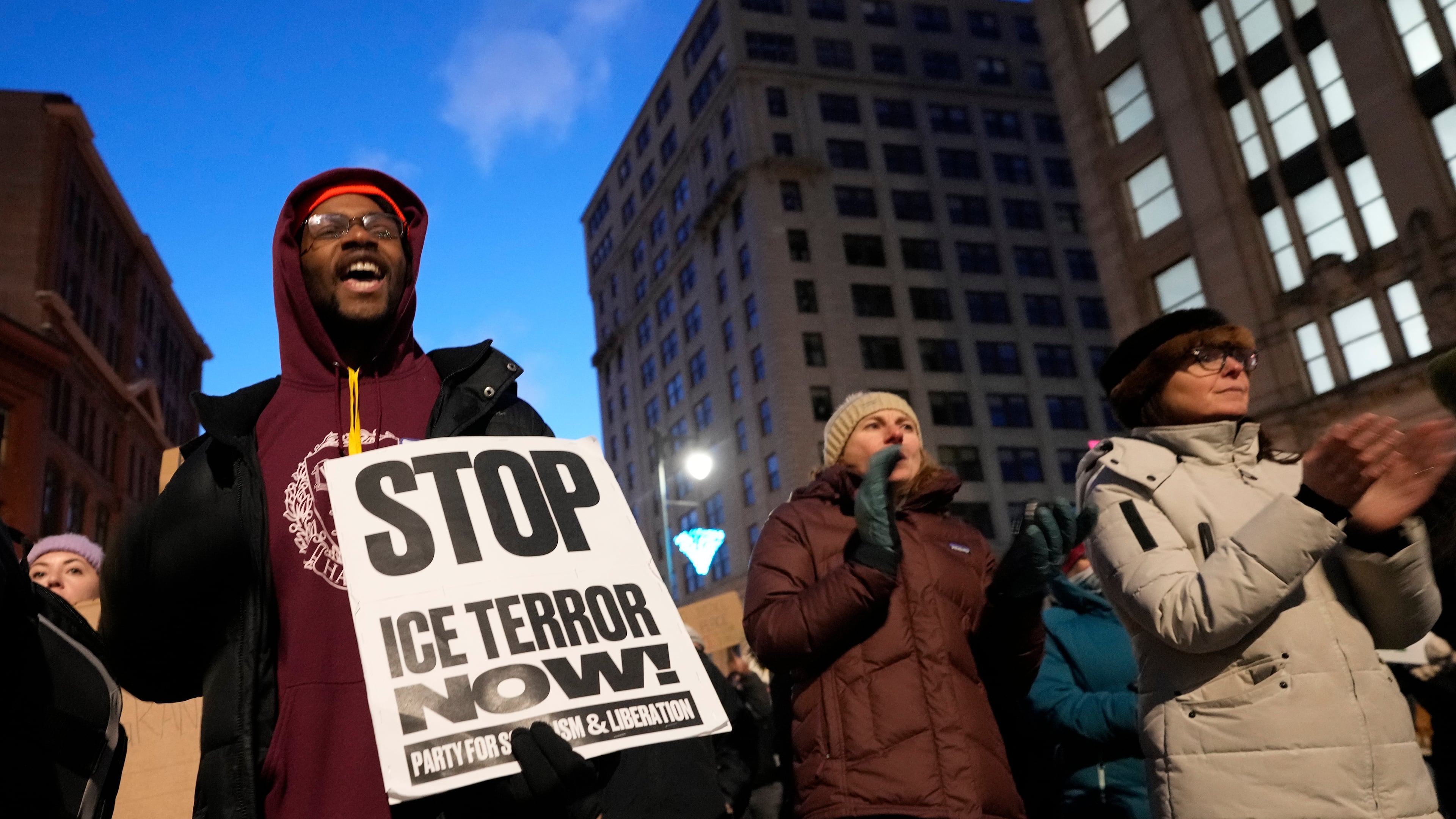 Protesters rally against the presence of U.S. Immigration Customs Enforcement in Maine, Friday, Jan. 23, 2026, in Portland, Maine. (AP Photo/Robert F. Bukaty)