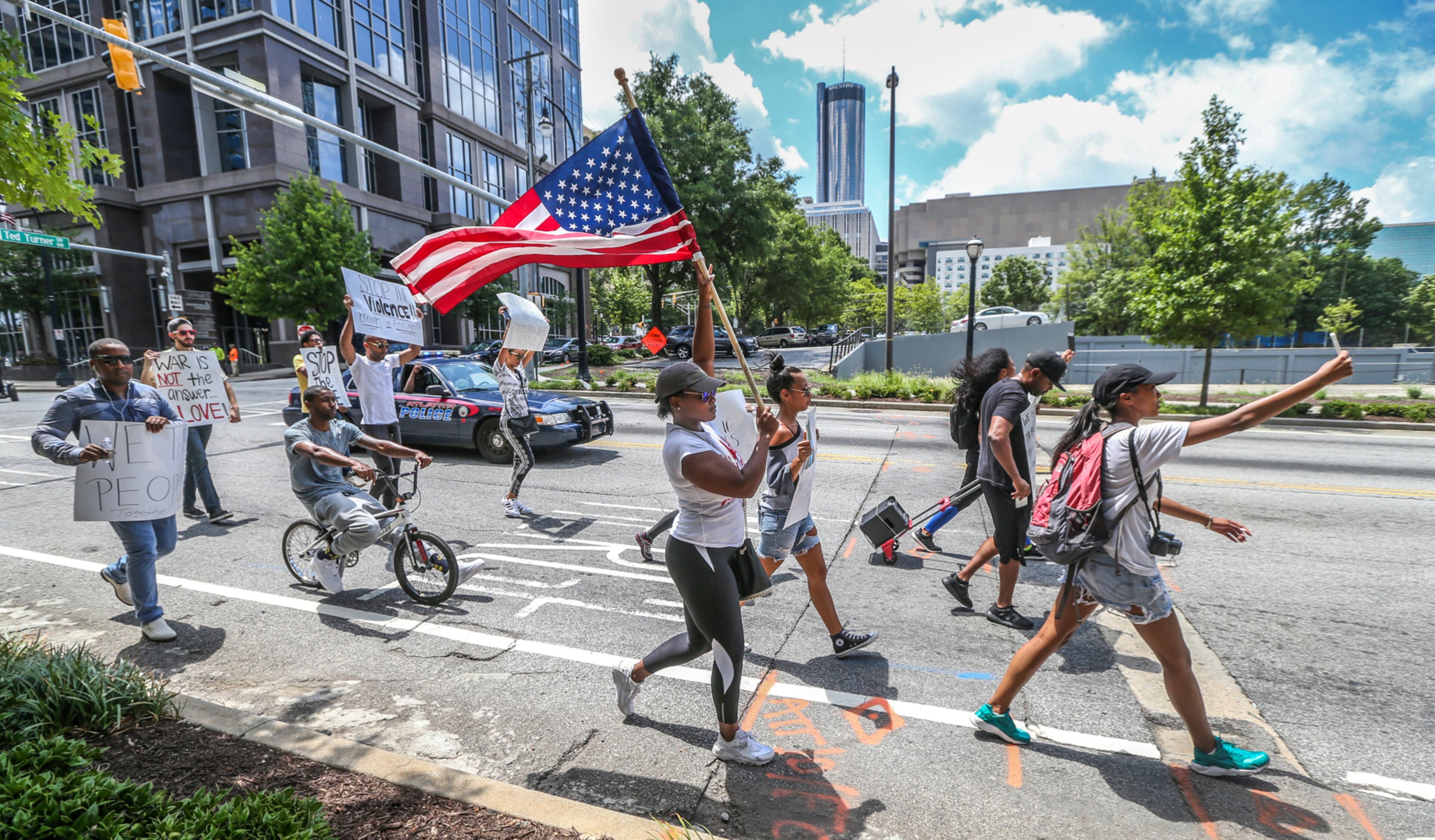 SECONDARY PHOTO ONLY !!! July 8, 2016 Atlanta: Protesters move towards the National Center for Civil and Human Rights on Ivan Allen Jr. Boulevard. The shooting of 12 police officers in Dallas, days after white officers killed two black men in Louisiana and Minnesota, prompted several demonstrations and protests Friday, July 8, 2016 in and around Atlanta. Around noon, about 35 people marched downtown, protesting the shootings. Carrie Choe organized the event through a social media post, to start a conversation about violence. âSomething has to change,â she said. âToday we are marching in protest of violence by police officers and by protesters ⦠more than anything, we are trying to build a positive relationships between us and police.â The group marched from 10th and Peachtree streets to the National Center for Civil and Human Rights. The marchers were not part of any official organization, Choe said, âweâre just mad citizens, mad Americans.â A separate demonstration, organized by the NAACP, was scheduled Friday afternoon at 6 p.m. also at the National Center for Civil and Human Rights. A local Black Lives Matter chapter is also planning to participate in that event. In a statement Friday, the NAACP condemned the violence in Dallas. âChange must come to policing in America but it cannot and will not come at the end of a barrel of a gunâ said Francys Johnson, Georgia NAACP president. Atlanta Mayor Kasim Reed, other city leaders and police officials were scheduled to hold a safety briefing Friday afternoon. Reed is expected to address the discovery of a man found hanged in Piedmont Park on Thursday. Hundreds of people marched in downtown Atlanta Thursday night to protest the police shootings and also in response to the hanging. Additional demonstrations are expected throughout the weekend, including a march Saturday morning on Barrett Parkway in Kennesaw and a community forum in DeKalb County with Cedric Alexander, DeKalbâs deputy chief operating officer for public safety. JOHN SPINK /JSPINK@AJC.COM