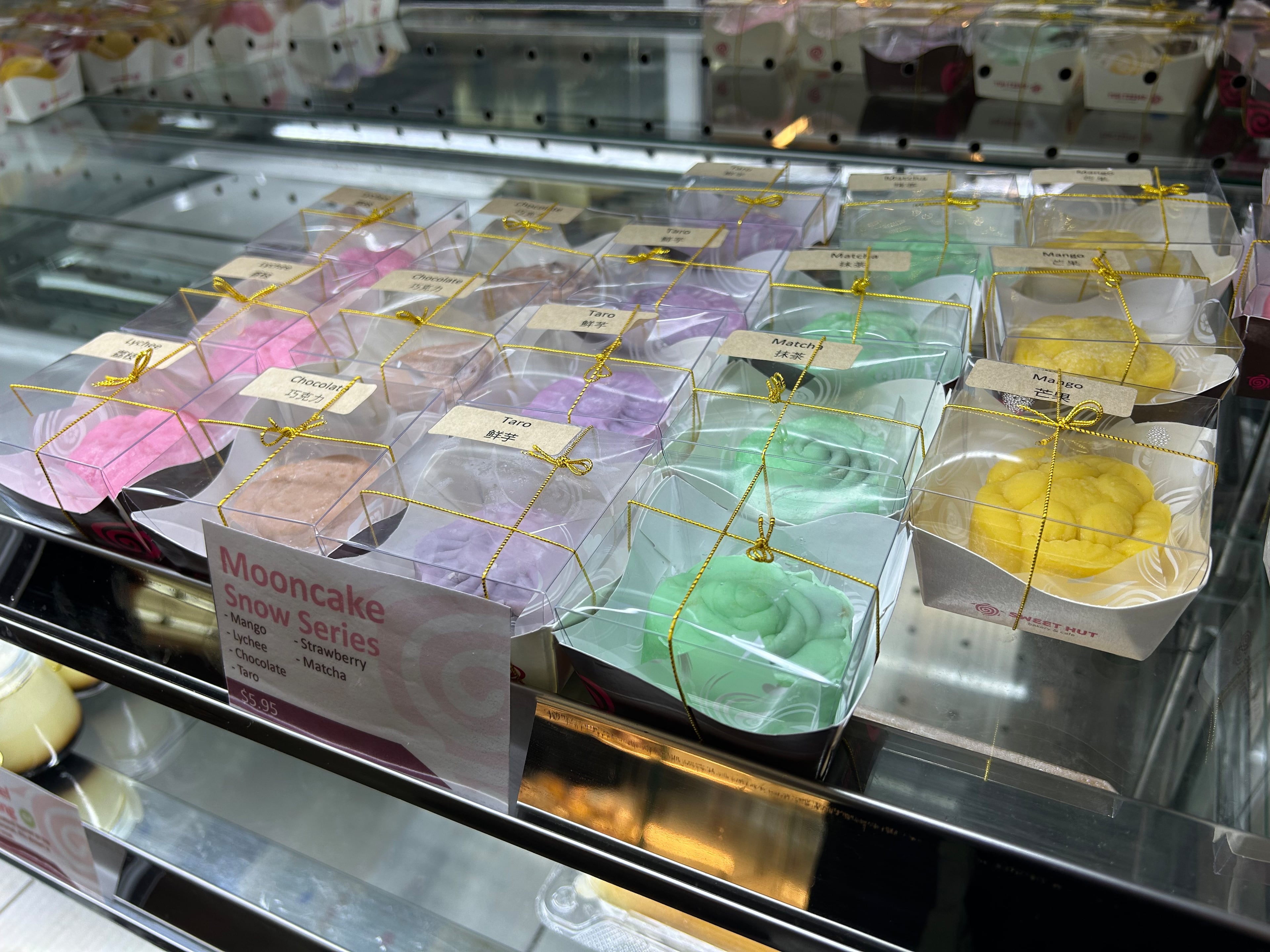 Snowskin mooncakes on display at Sweet Hut Bakery in Kennesaw come in flavors such as lychee, chocolate and mango. (Candy Hom for the AJC)