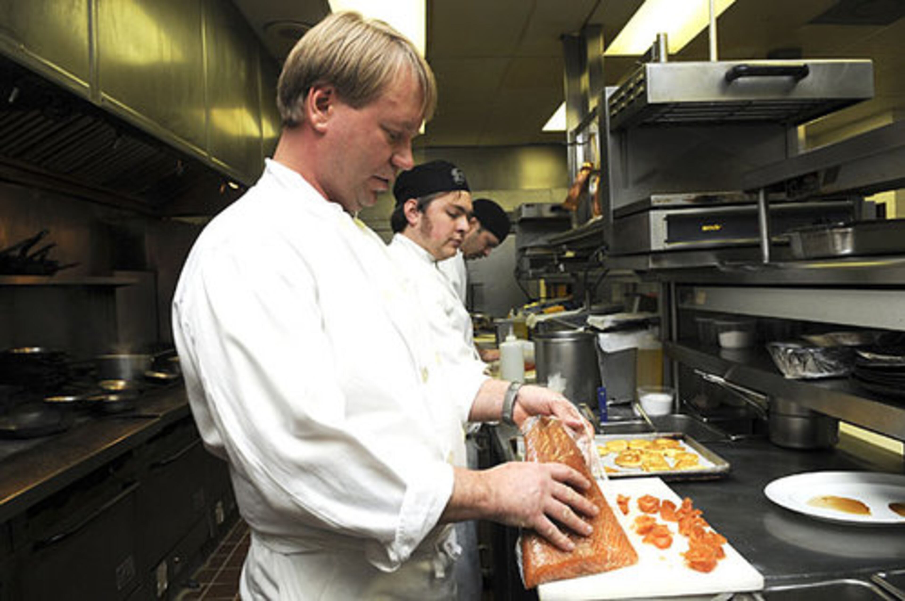 Chef Gary Donlick in the kitchen with salmon.