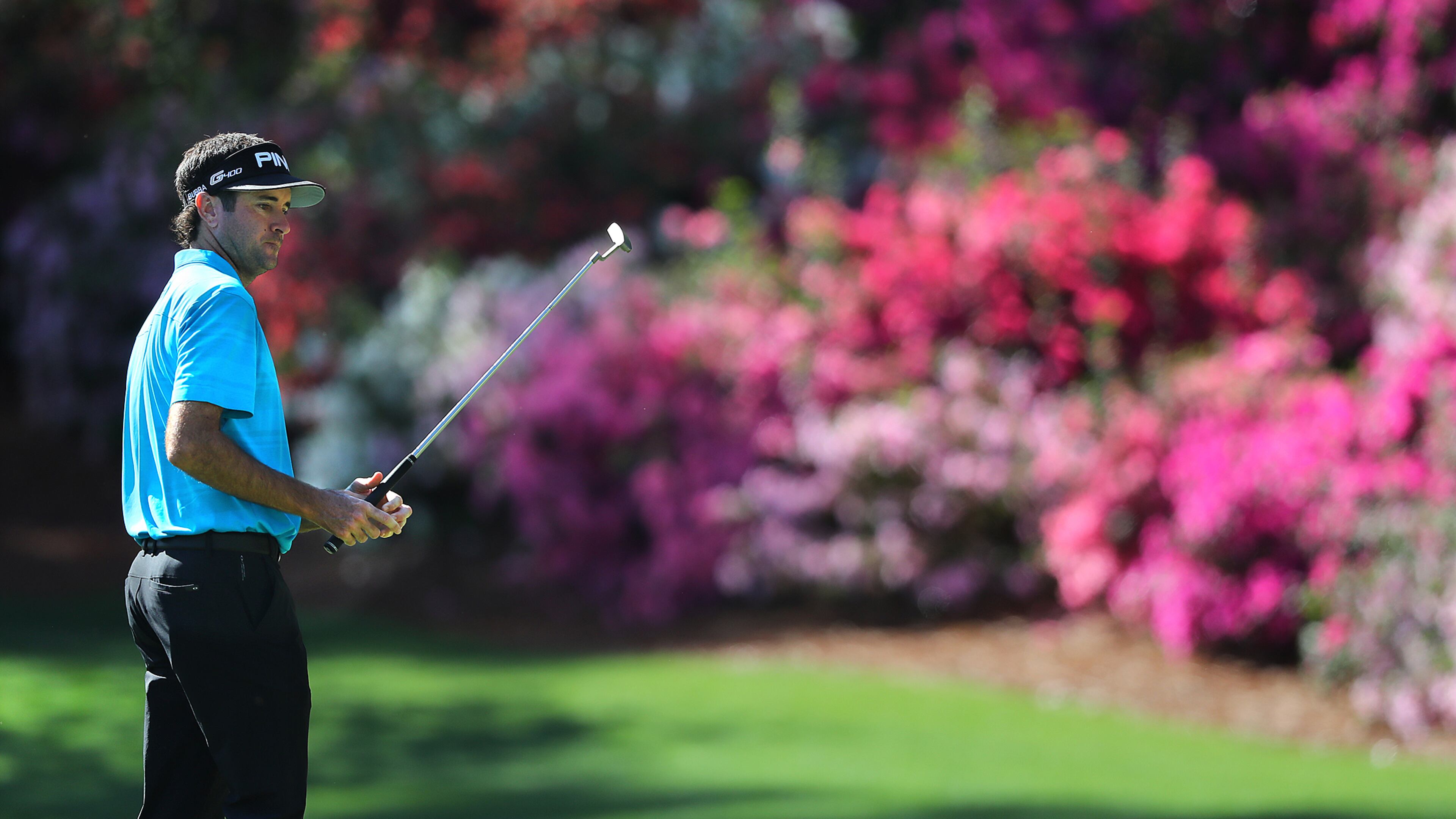 The azaleas are in full bloom as Bubba Watson watches his putt on the 13th green during his practice round for the Masters Monday, April 2, 2018, at Augusta National Golf Club.