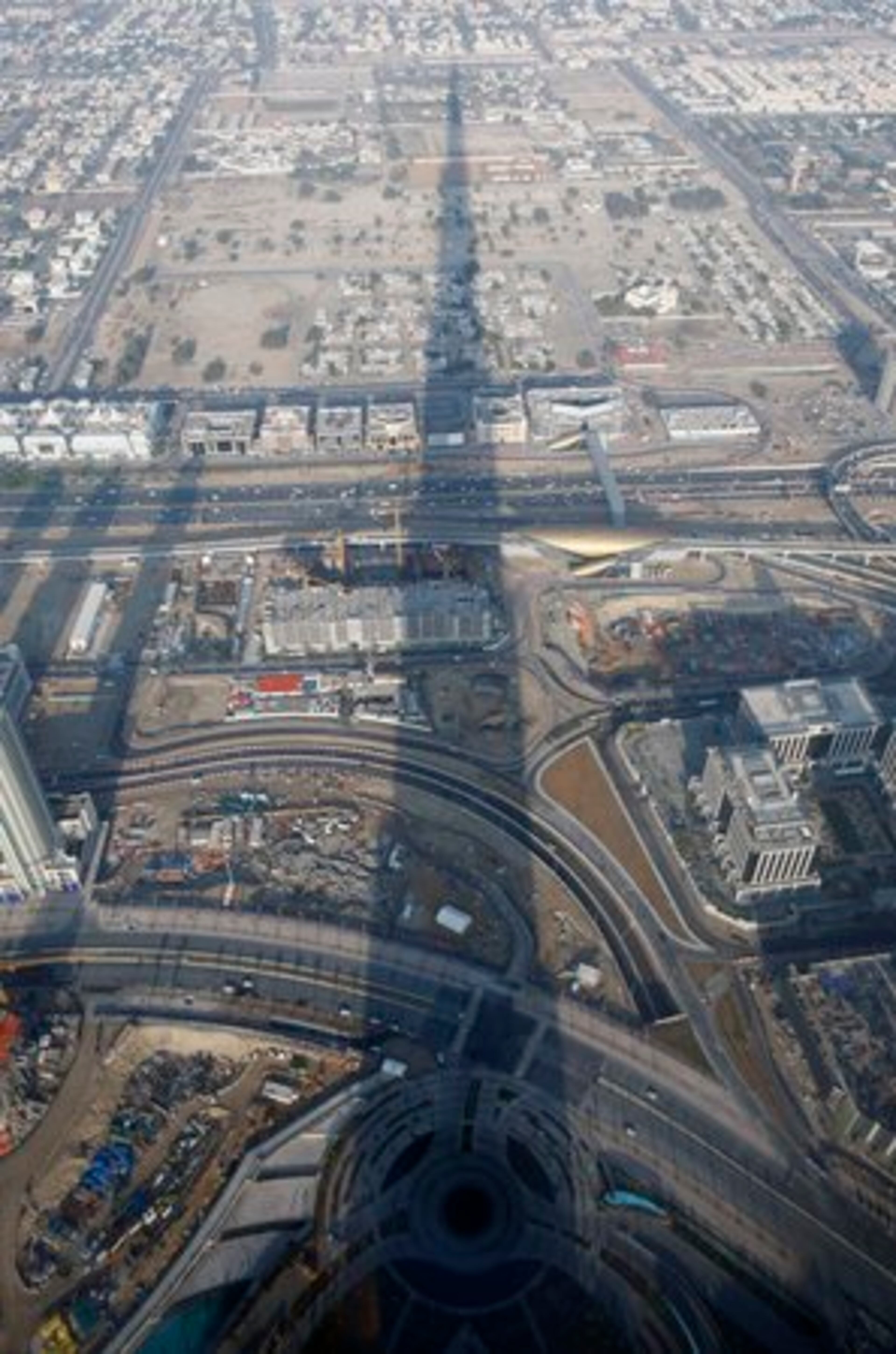 The shadow from the spire stretches far across the city.