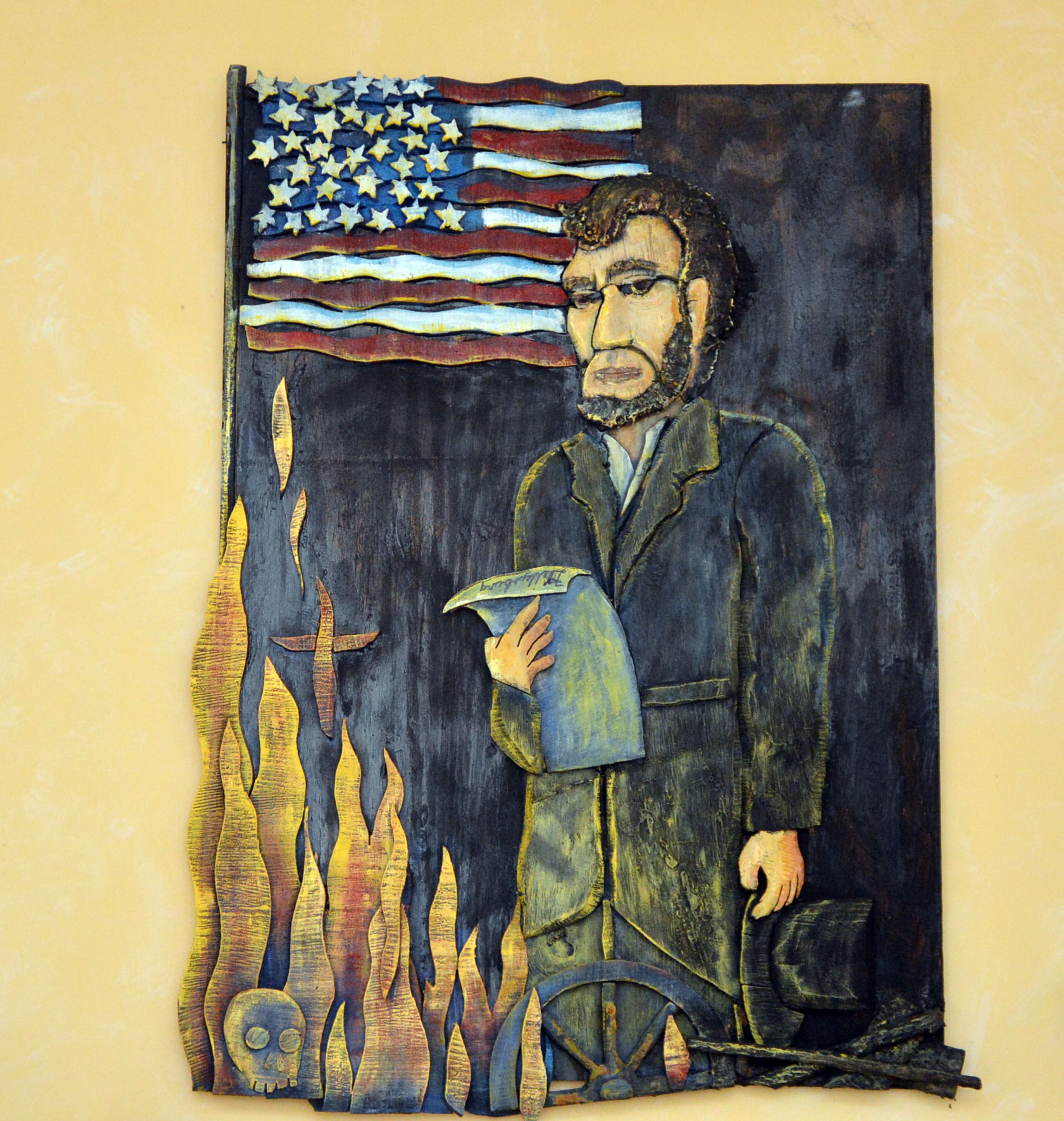 A painting of Abraham Lincoln with a flag and the flames of the Civil War in Gene Griessman's Sandy Springs home.