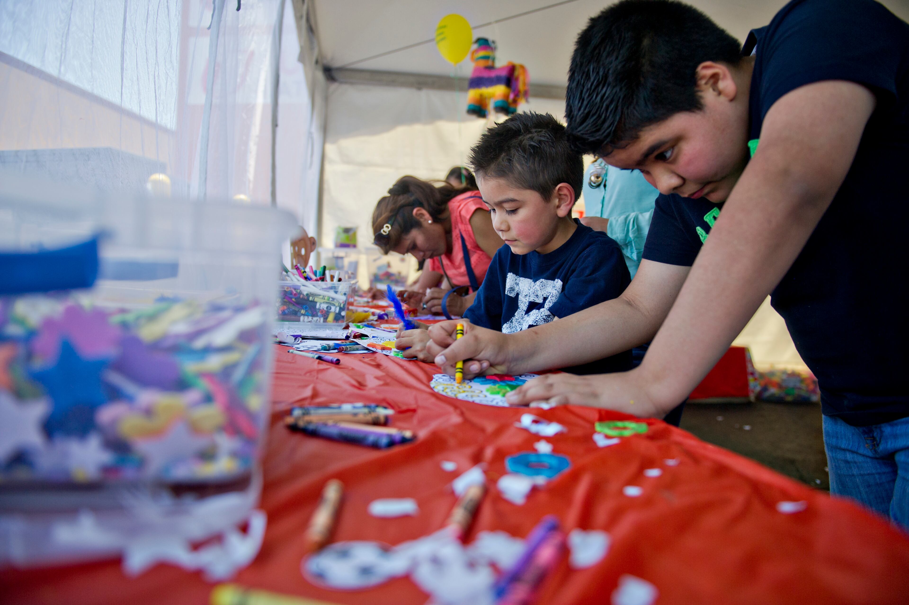 Dario Escobedo (right) and his brother Zuirel work on a craft project during the Cinco de Mayo Festival at Plaza Fiesta in Atlanta on Sunday, May 4, 2014.