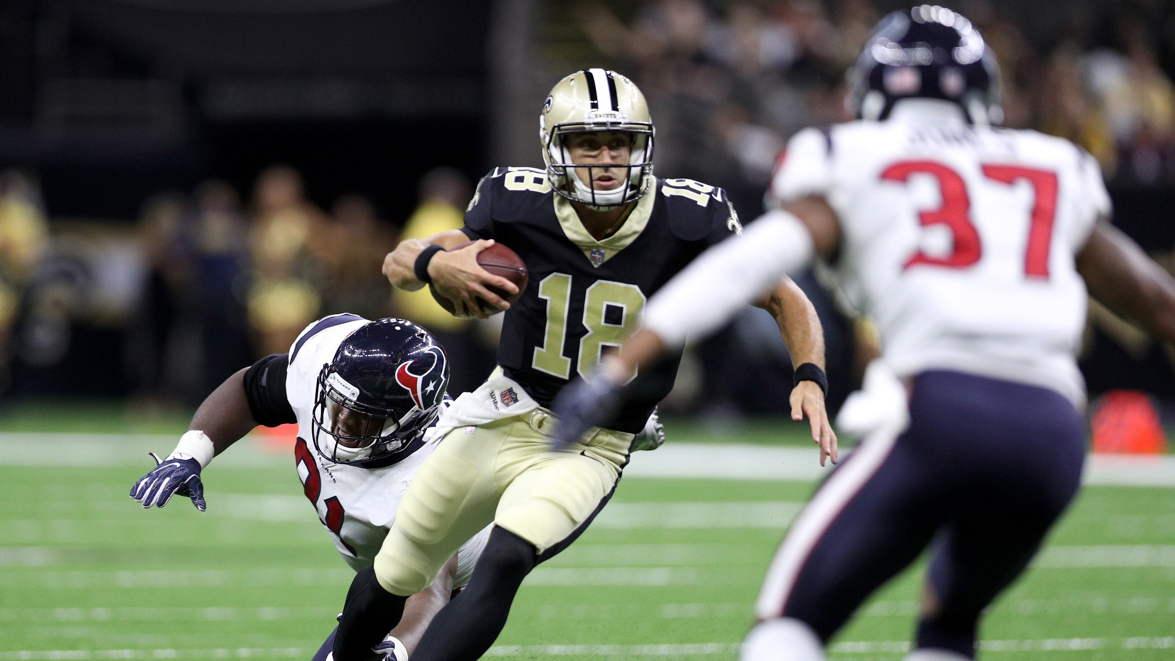 Garrett Grayson (18) of the New Orleans Saints avoids a tackle by Bryce Jones of the Houston Texans at Mercedes-Benz Superdome on August 26, 2017 in New Orleans, Louisiana. (Photo by Chris Graythen/Getty Images)