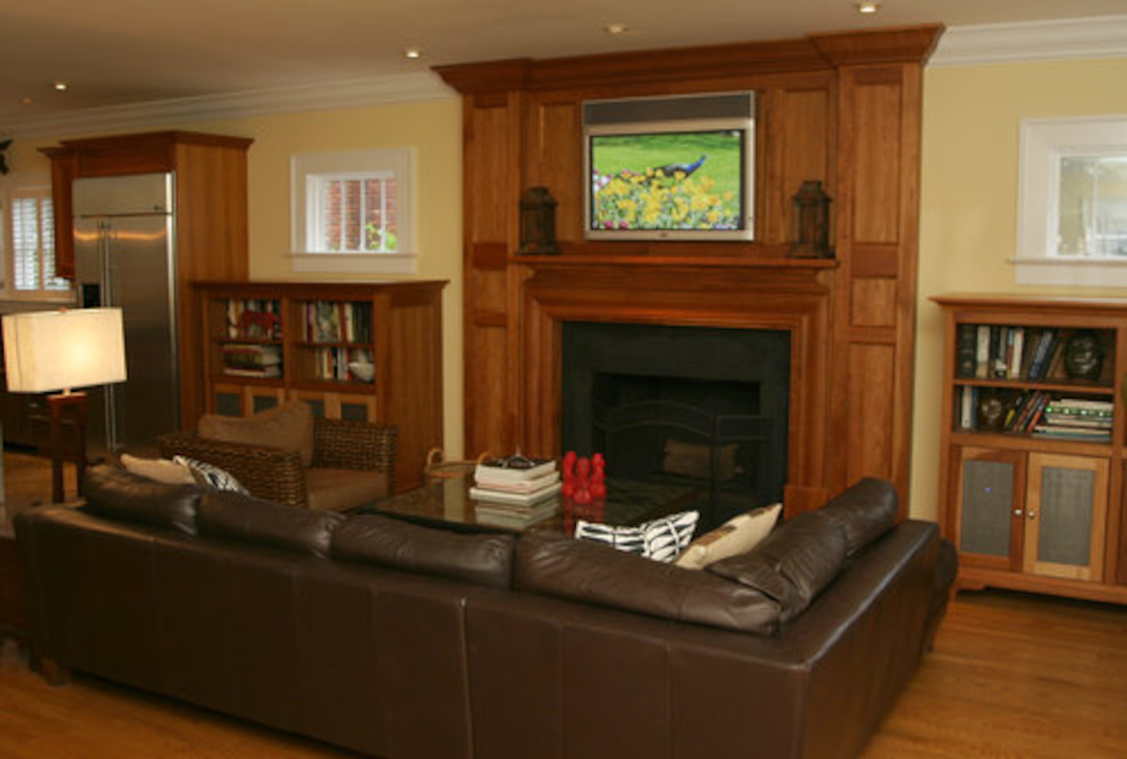 The floor-to-ceiling mantel matches the wood used in the kitchen cabinetry, adding a cohesive look to the family area. Logue says this is where they spend most of their time. "I always wanted to have a home where my kids' friends wanted to come and hang out," he says.