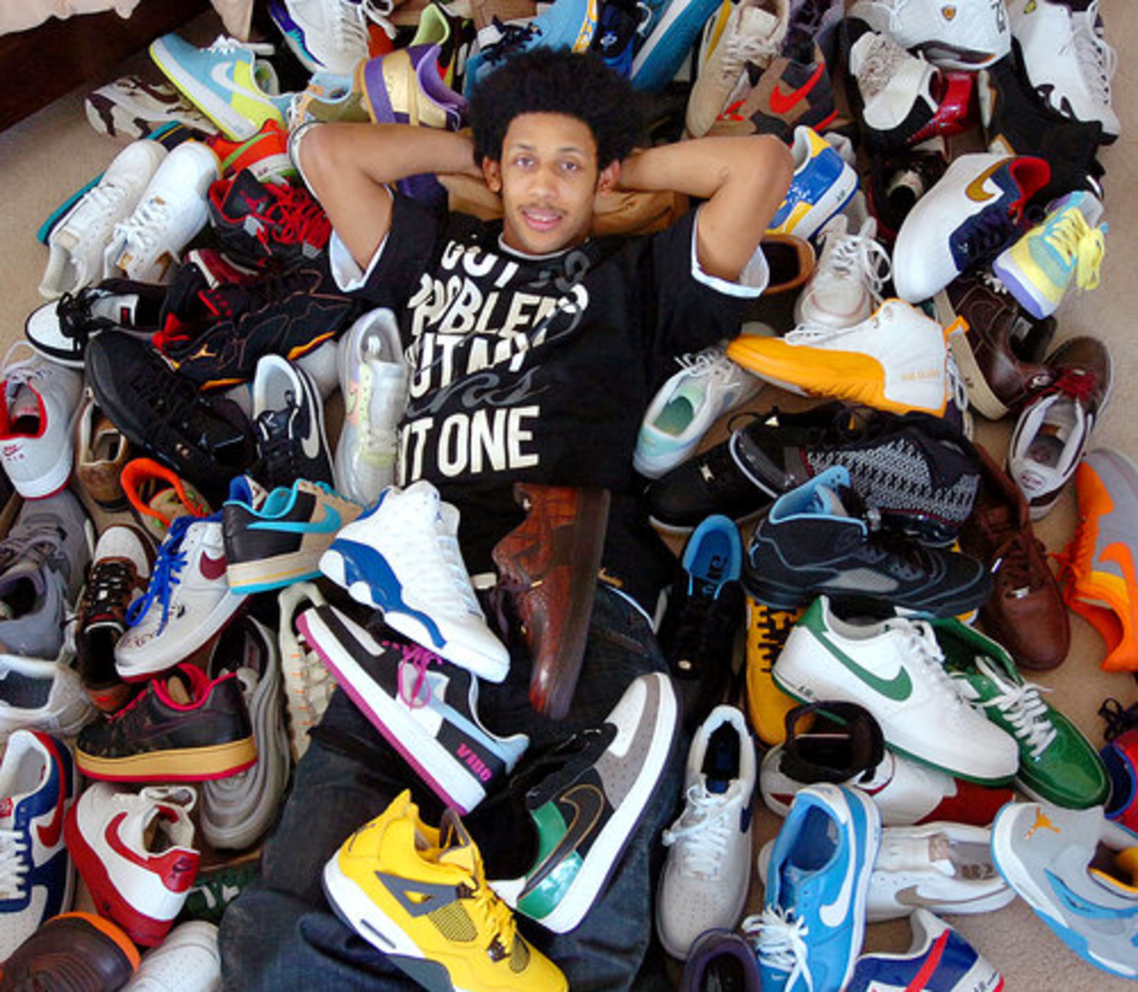 Josh Childress is surrounded by a part of his shoe collection.
