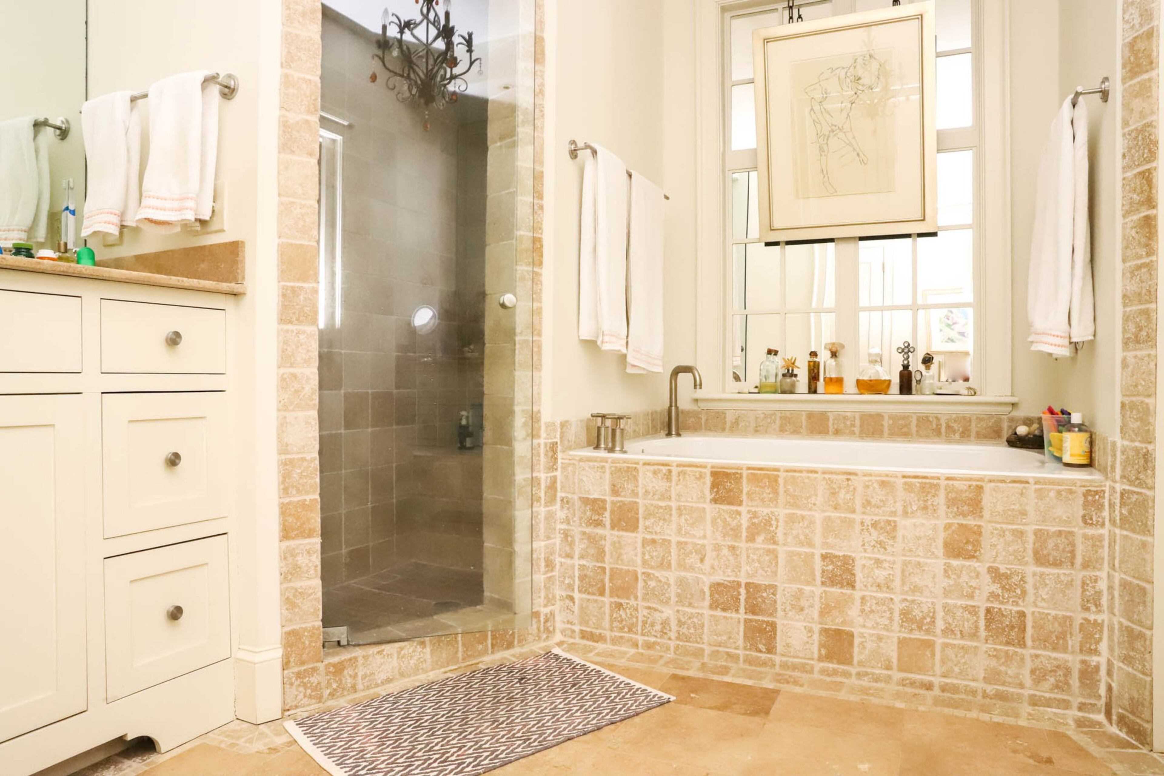 Nancy and Gene Hooff’s master bathroom is light and spa-like, with a mirror hanging over the bath to provide the illusion of a window and open up the space while providing the privacy of a closed room. Text by Shannon Dominy. Photo by Reynolds Rogers.