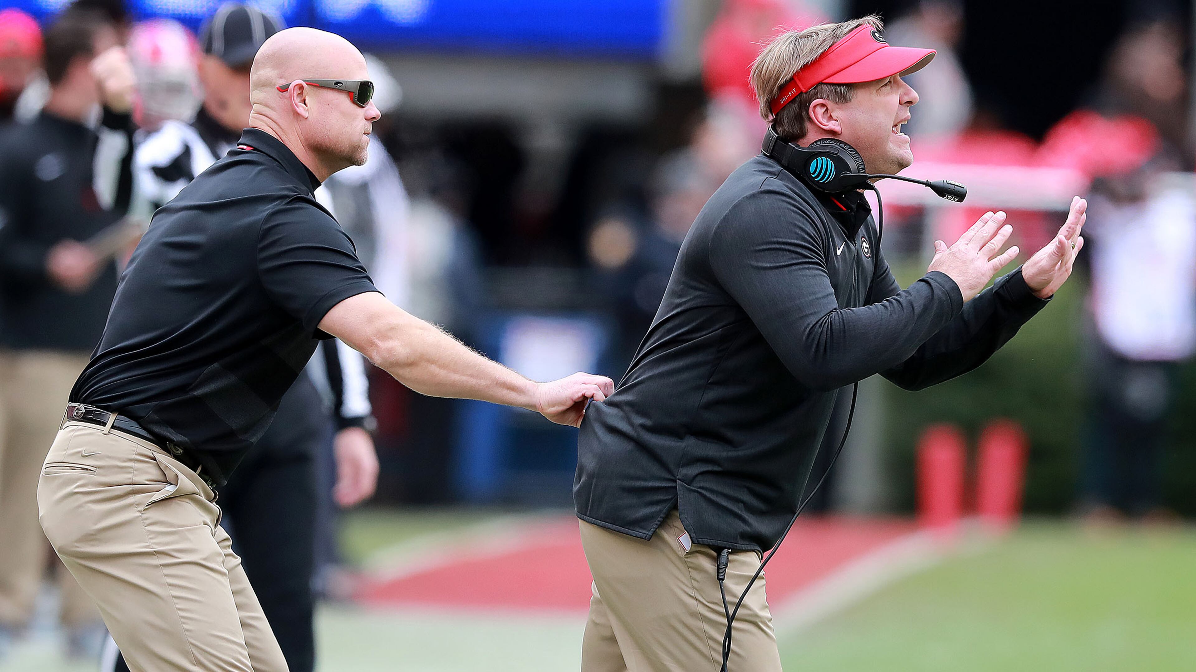 Scott Sinclair has to literally hold back Kirby Smart on the sidelines during the first half against Georgia Tech in their NCAA college football rivalry game on Saturday, Nov. 24, 2018, in Athens. Curtis Compton/ccompton@ajc.com