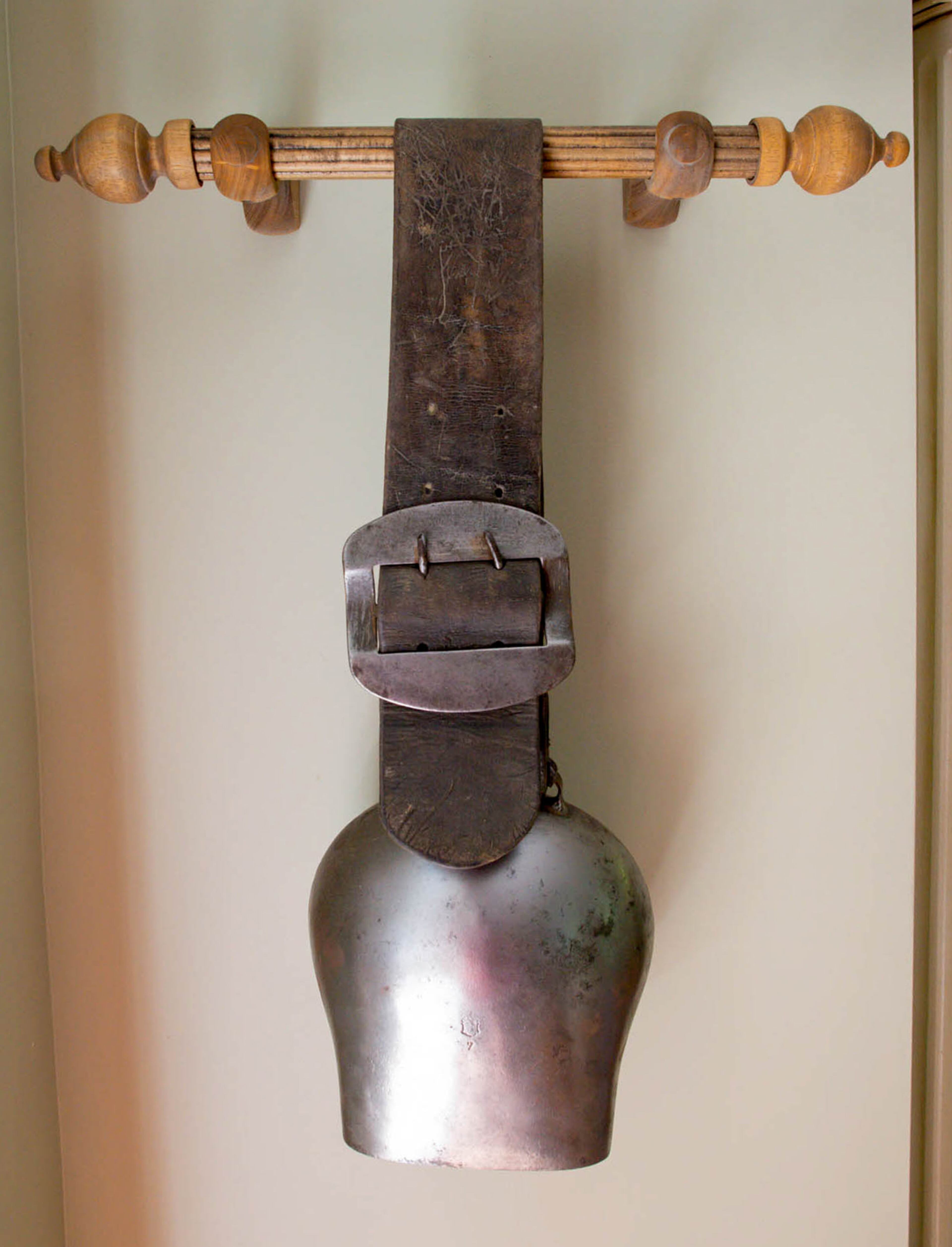 An early 20th century cowbell from Switzerland hangs on the wall in Tony and Judy Ragunas' kitchen.